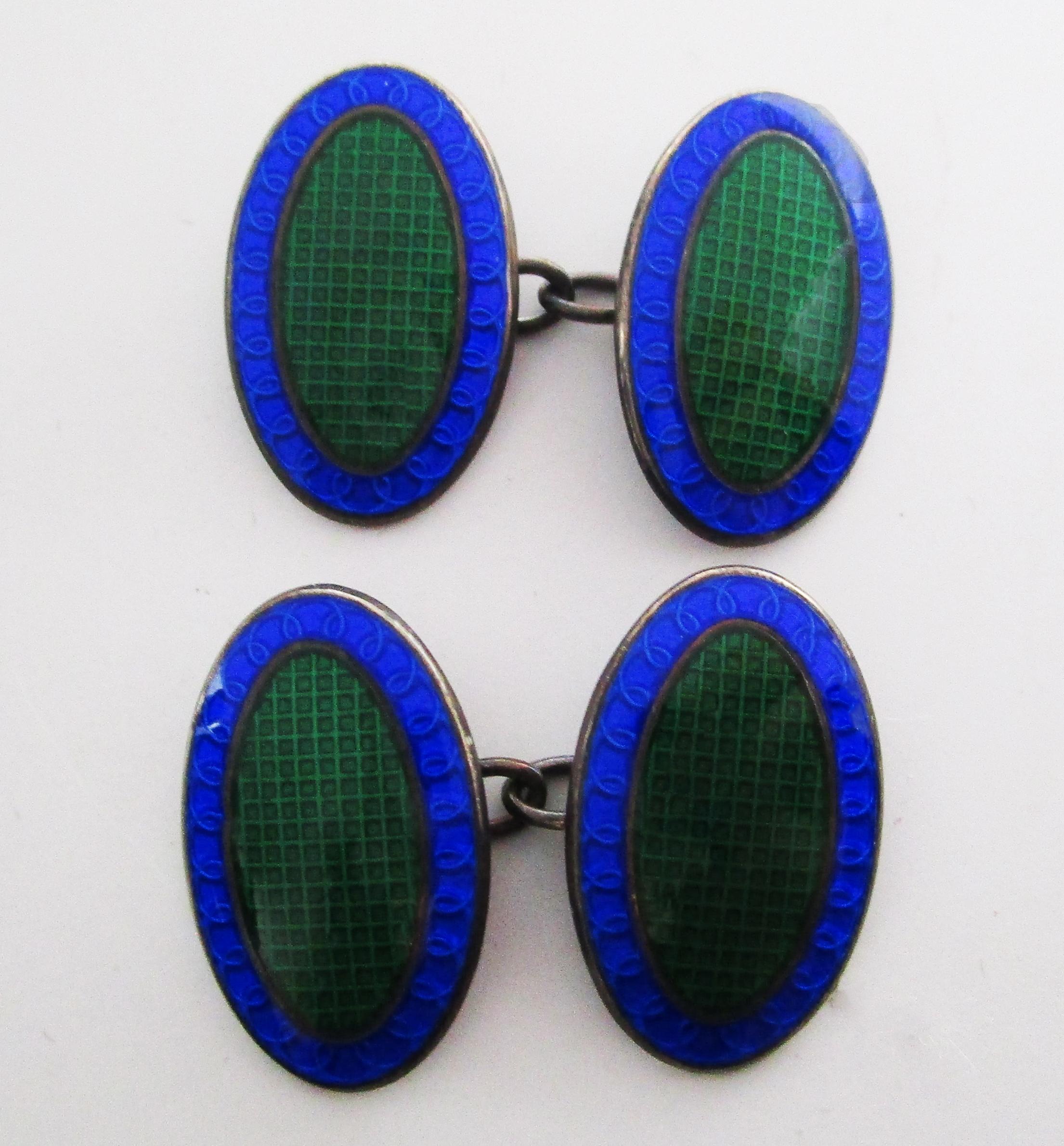 These are an excellent pair of cufflinks in sterling silver and enamel with a striking green and blue color scheme and a subtle grid pattern guilloche field. The bright colors of the enamel make these links particularly noticeable. The subtle grid