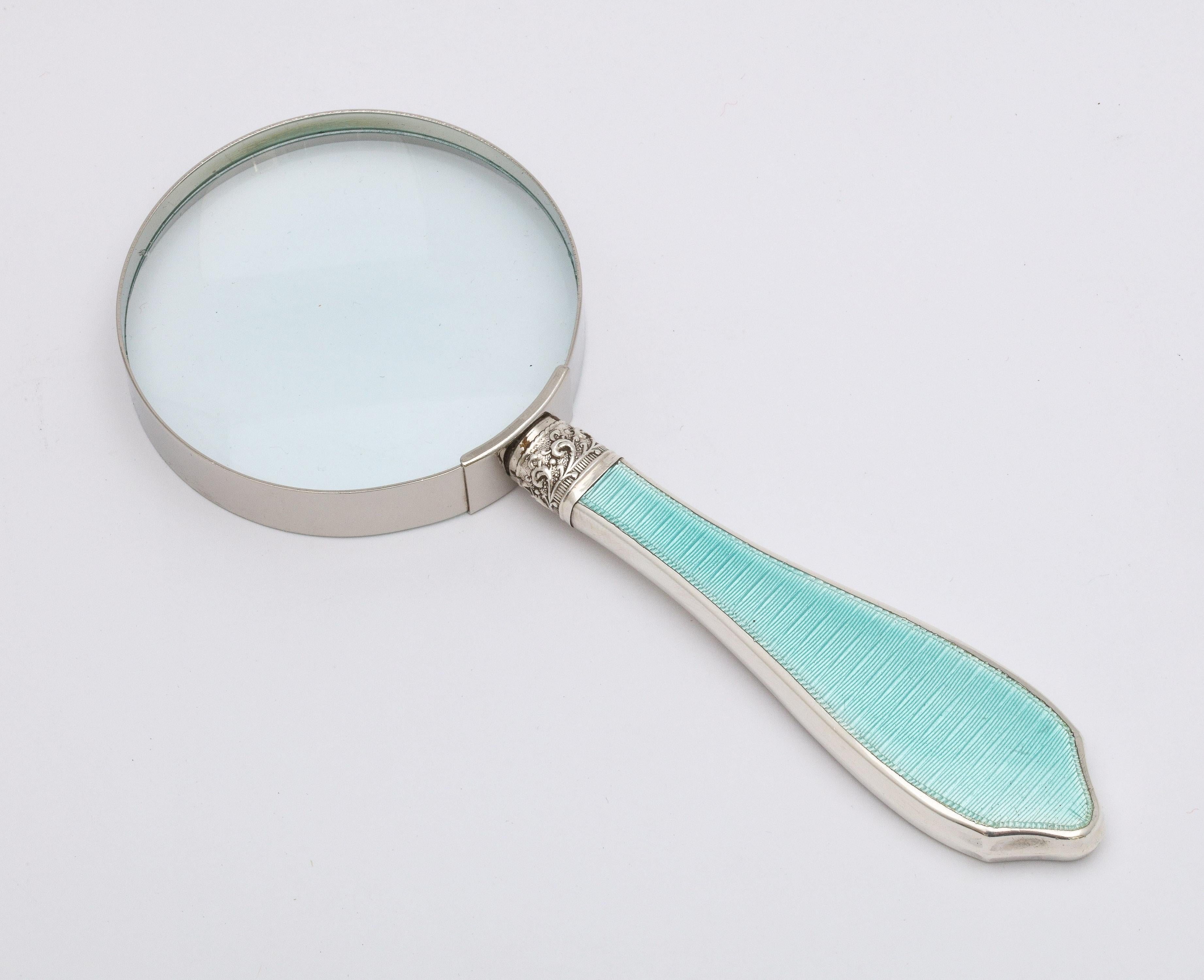 Art Deco, sterling silver and light turquoise guilloche enamel-mounted magnifying glass, Birmingham, England, year-hallmarked for 1928, W.I. Broadway and Co. - makers. Measures 6 1/2 inches long x over 2 1/2 inches diameter across glass. Glass