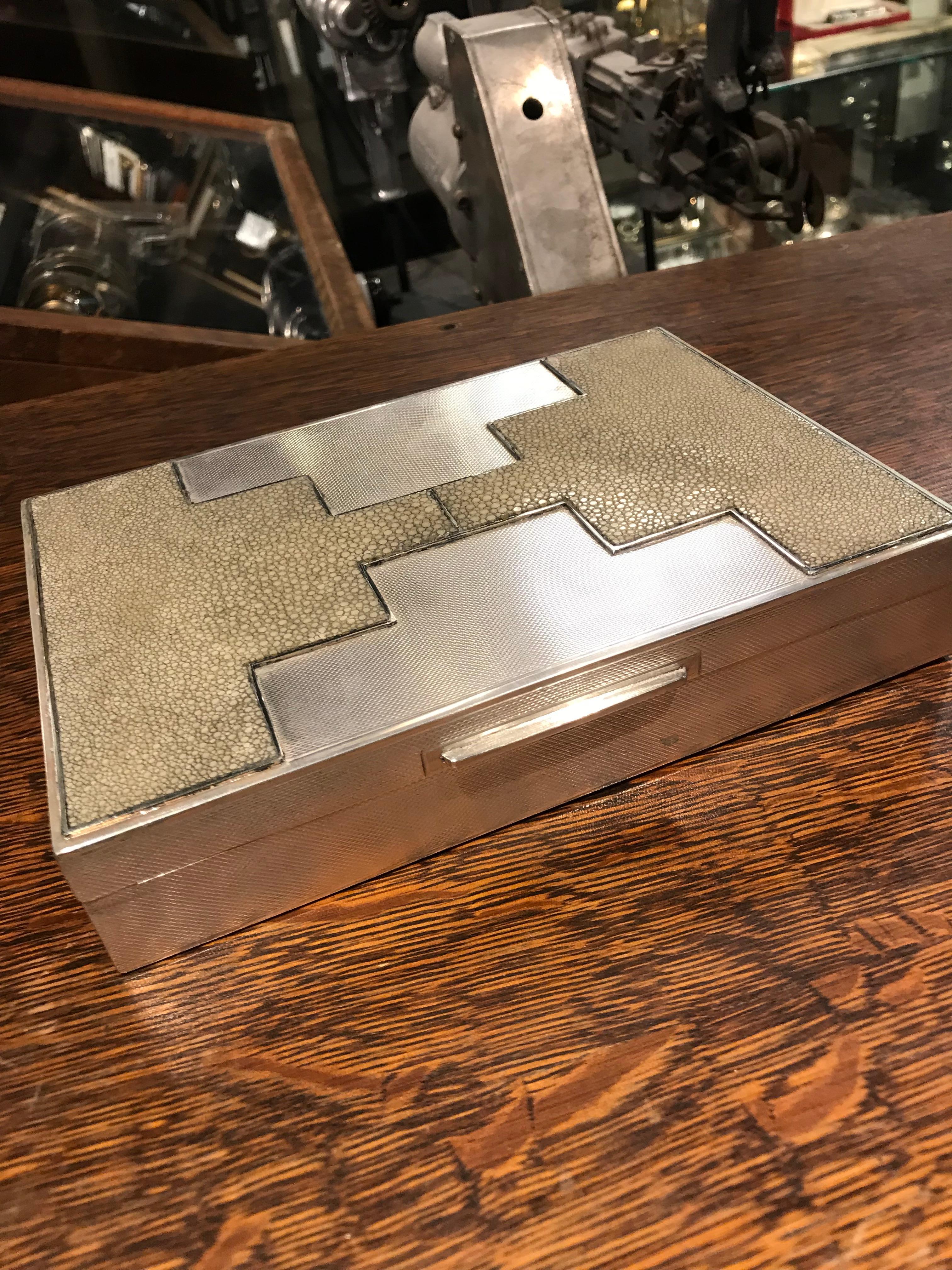 An incredible example of Art Deco luxury. This box has an engine turned texture with shagreen embellished in a skyscraper motif. Great scale and exemplary craftsmanship.
