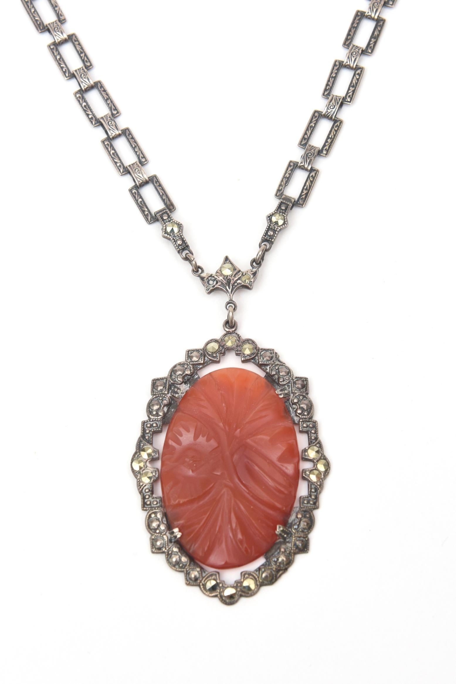 This lovely art deco vintage carnelian, sterling silver and marquisette necklace lays beautifully on the chest. The carnelian stone which is the pendant is surrounded by marquisettes. Could go day to evening. Please double check with us for exact
