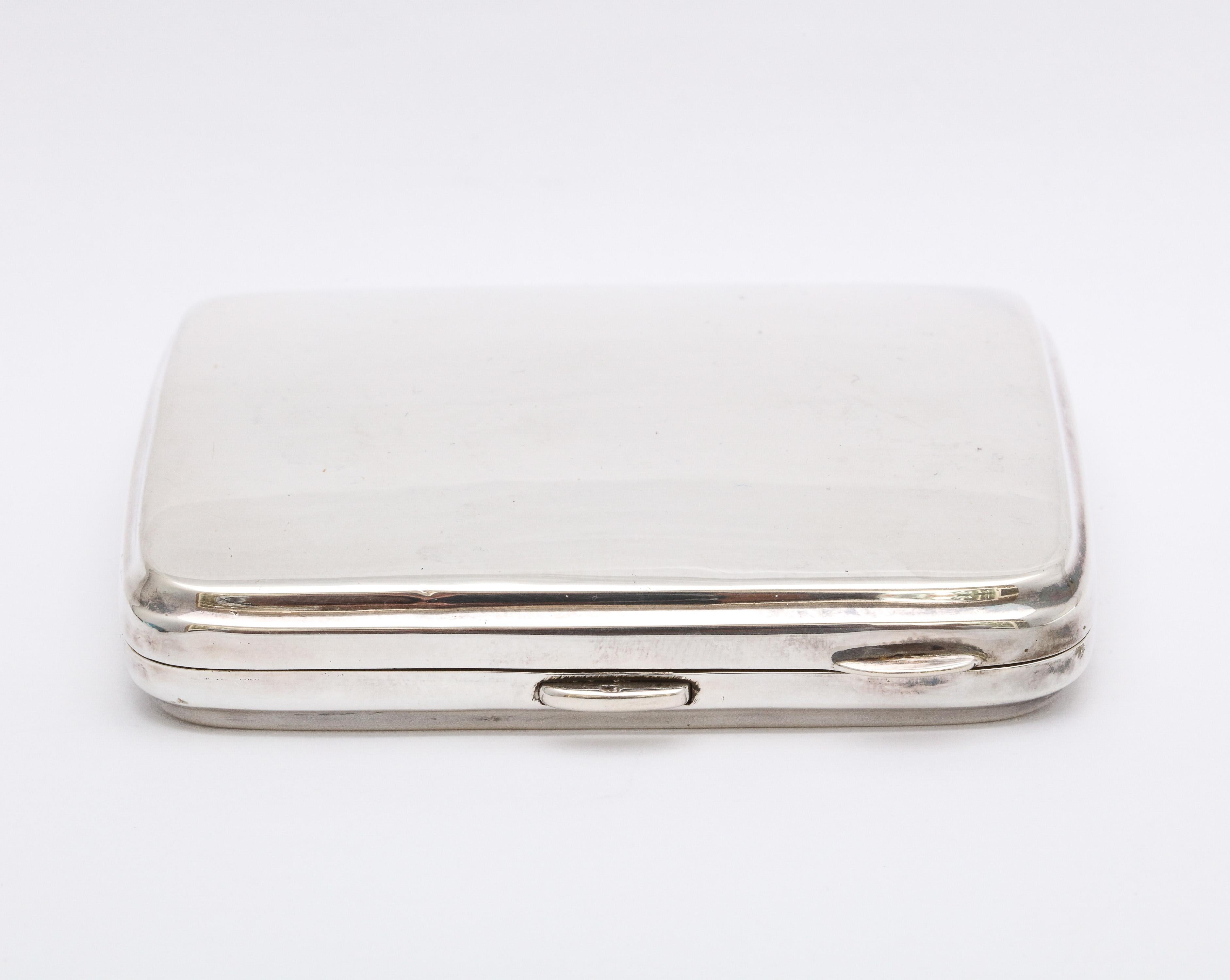 Art Deco, sterling silver cigarette case, Birmingham, England, year hallmarked for 1923, William Haseler - maker. Clean lines; gilded interior. When closed, measures 3 3 1/4 inches wide (including clasp) x 3 1/4 inches deep x 1 1/8 inches high; when