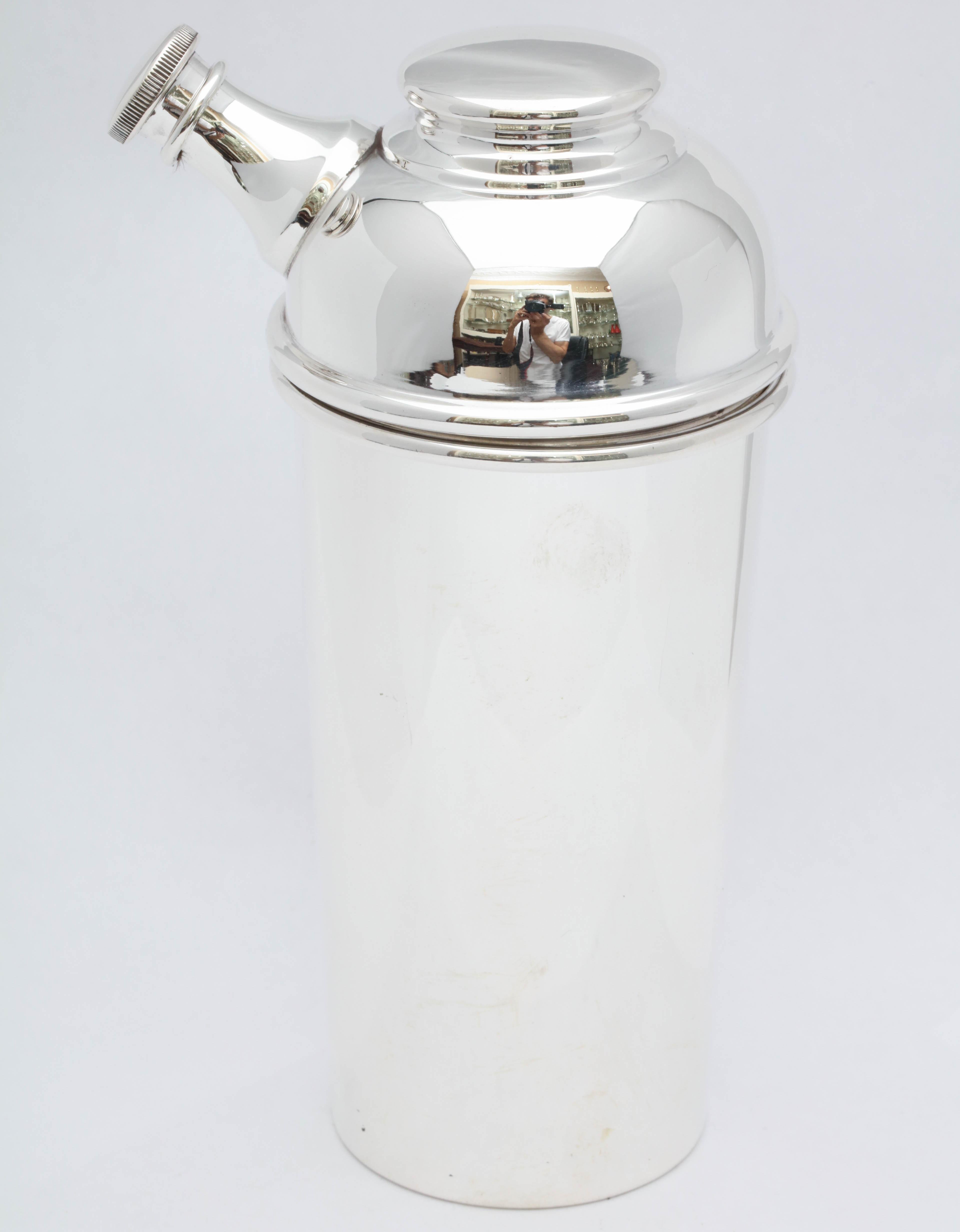 Art Deco, sterling silver cocktail shaker, Fisher Silversmiths, Inc., New Jersey, circa 1930s. Measures 7 inches high x 3 inches in diameter at widest point x 4 inches deep from spout to edge of shaker. Weighs 7.050 troy ounces. Dark spots in photos