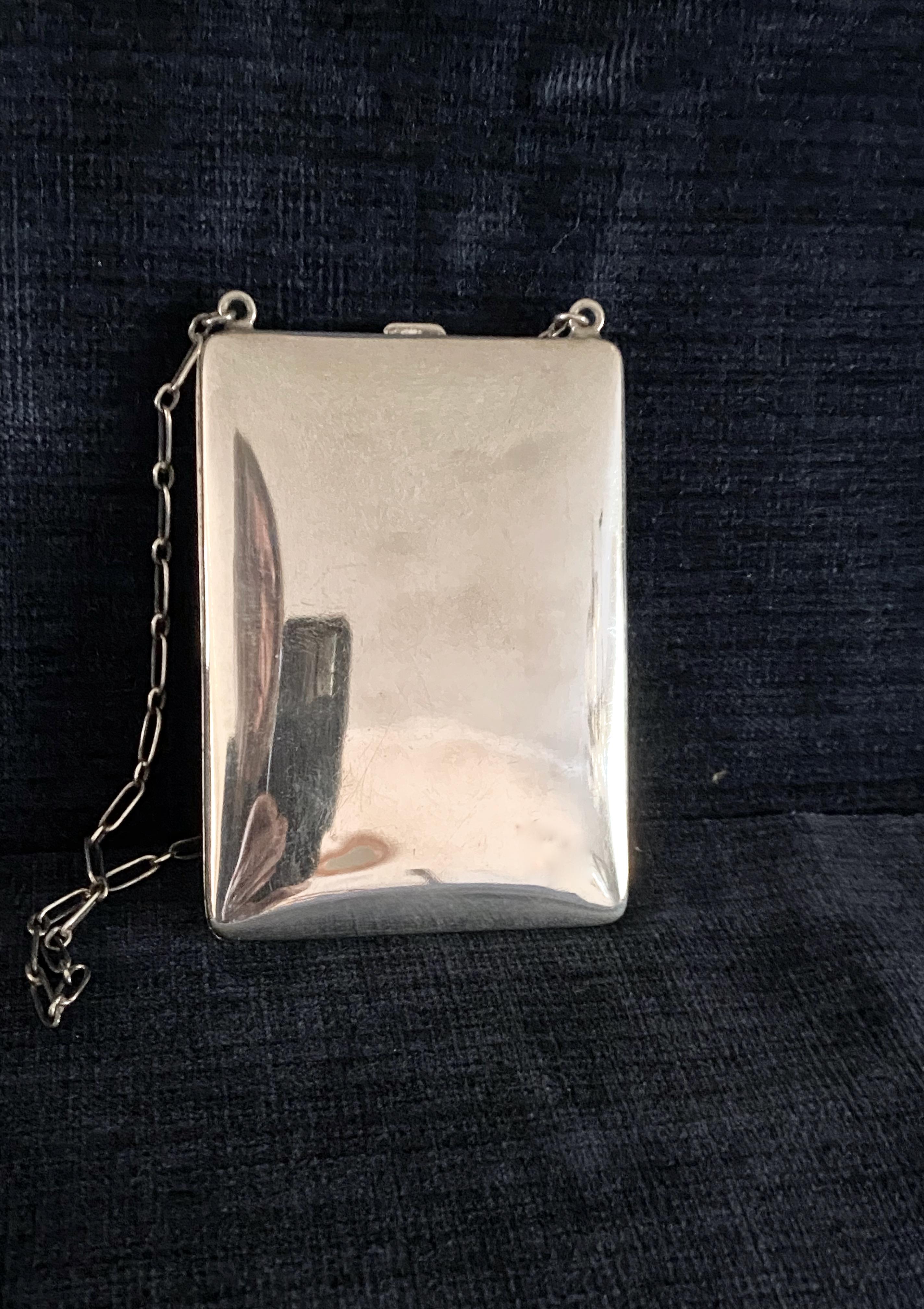 This is a beautifully crafted Art Deco period Sterling Silver Lady's Compact or necessaire. This stunning engraved and monogrammed compact opens to reveal a sterling silver interior with fittings for two different types of coins and a covered powder