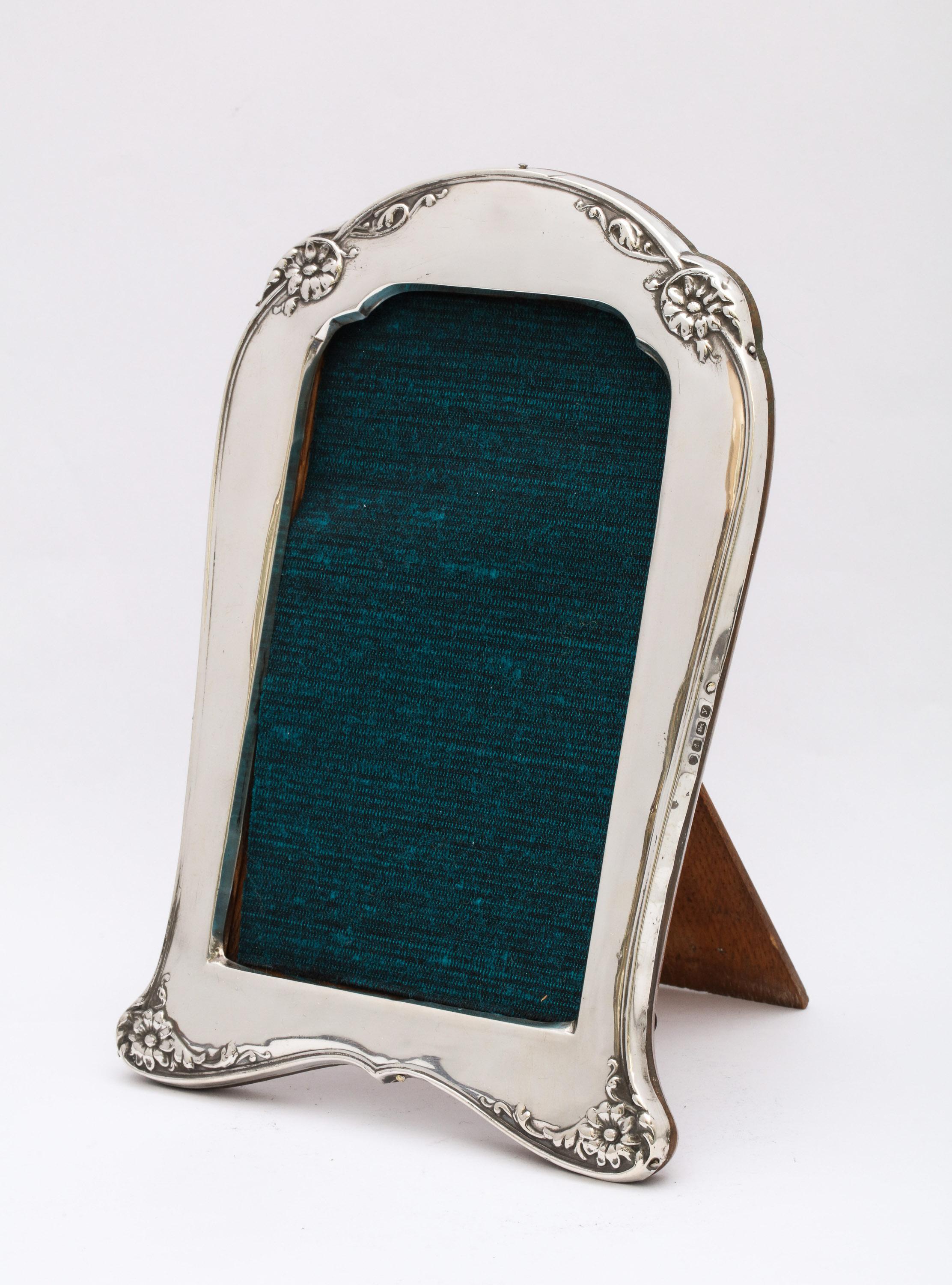Art Deco, sterling silver, footed, wood-backed picture frame with floral decoration, Birmingham, England, 1923, Charles S. Green and Company - makers. Measures 7 1/2 inches high (at highest point) x 5 1/2 inches wide (at widest point) x 4 1/2 inches