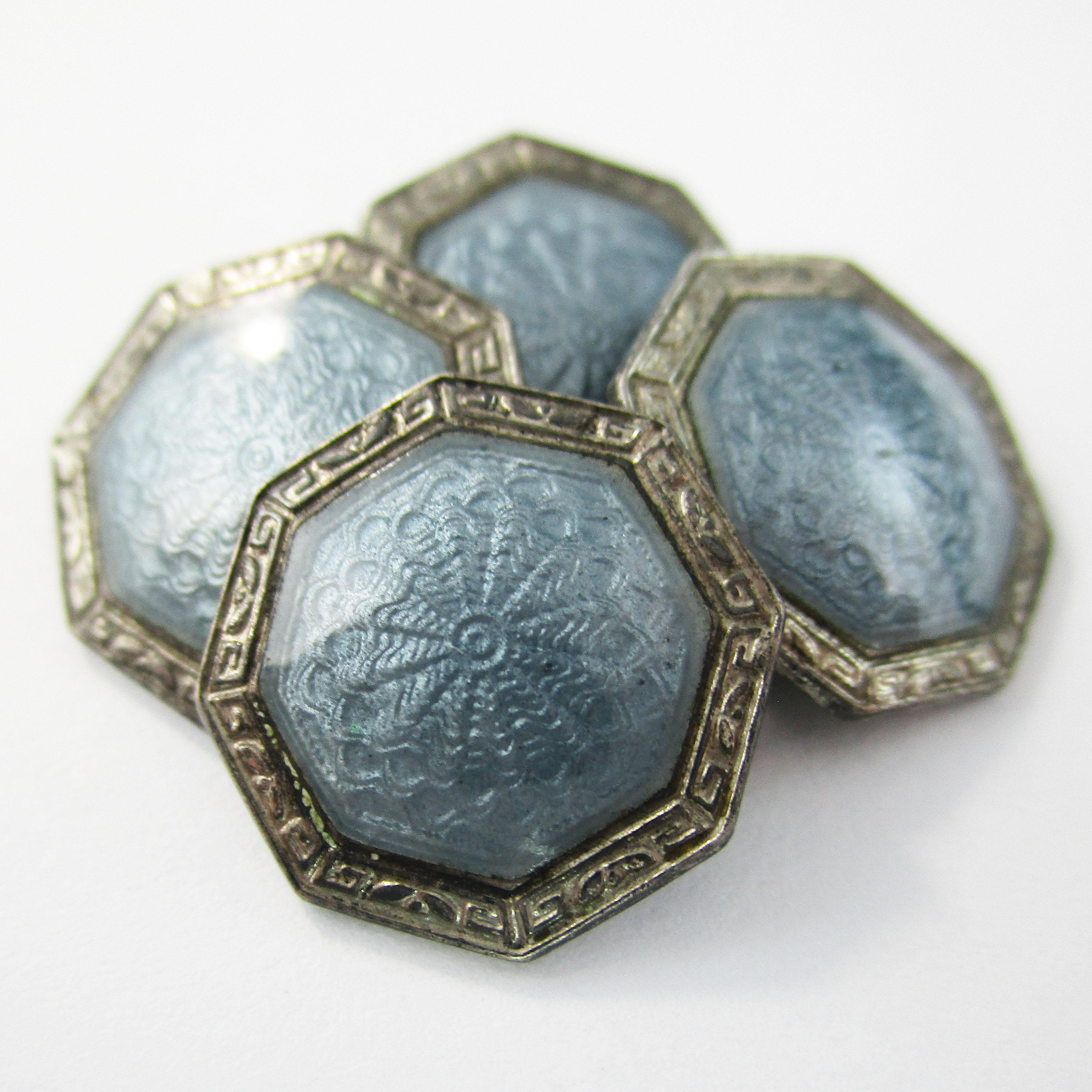 This is an excellent pair of Art Deco cufflinks in sterling silver with gorgeous gray guilloche enamel panels. The enamel is in incredible condition and has a subtlety of detail that creates a reflective, dimensional appearance. The enamel has a