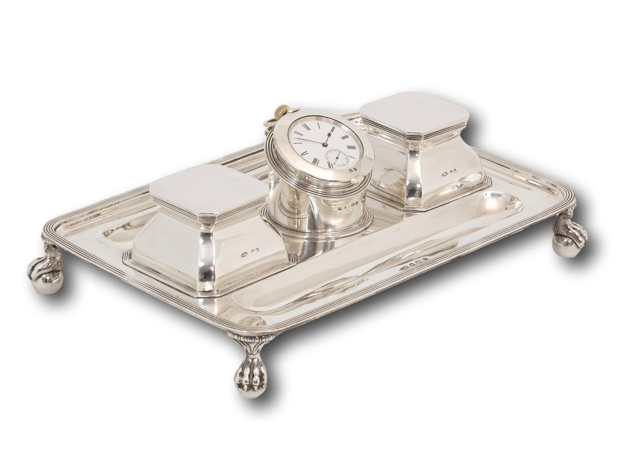 Two Ink Wells & Pocket Watch Holder

From our Silver collection, we are pleased to offer this Art Deco Silver Desk Stand. The Ink Desk Stand cast in Sterling Silver and raised upon four ball and claw feet is shaped into a rectangle with two pen tray