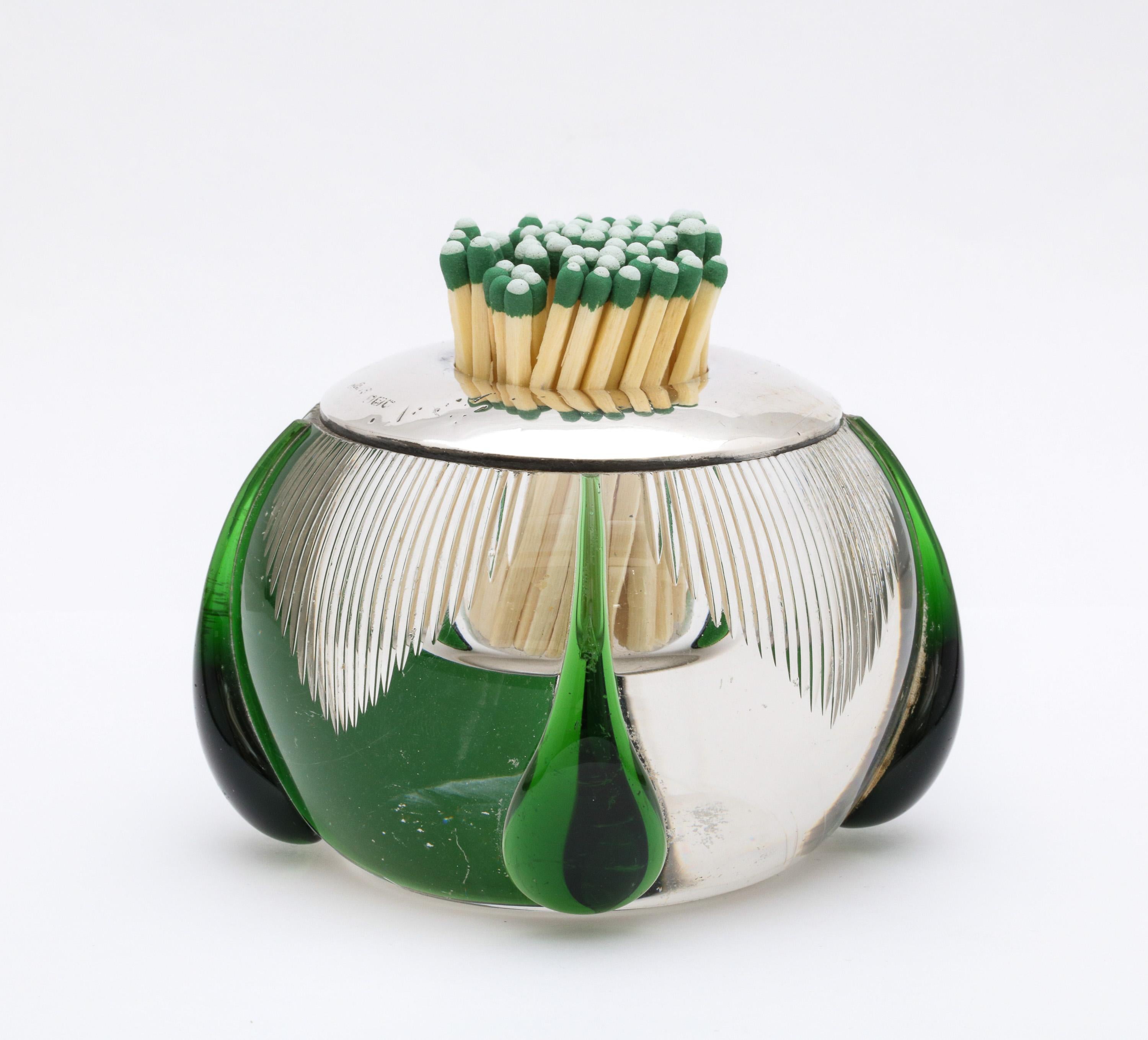 Large, unusual Art Deco sterling silver-mounted, clear, hand blown crystal match striker, having four, hand blown, dark green tear drop shaped designs blown onto the clear part of the crystal. London, 1919, Henry Hobbs and Sons - makers. The matches