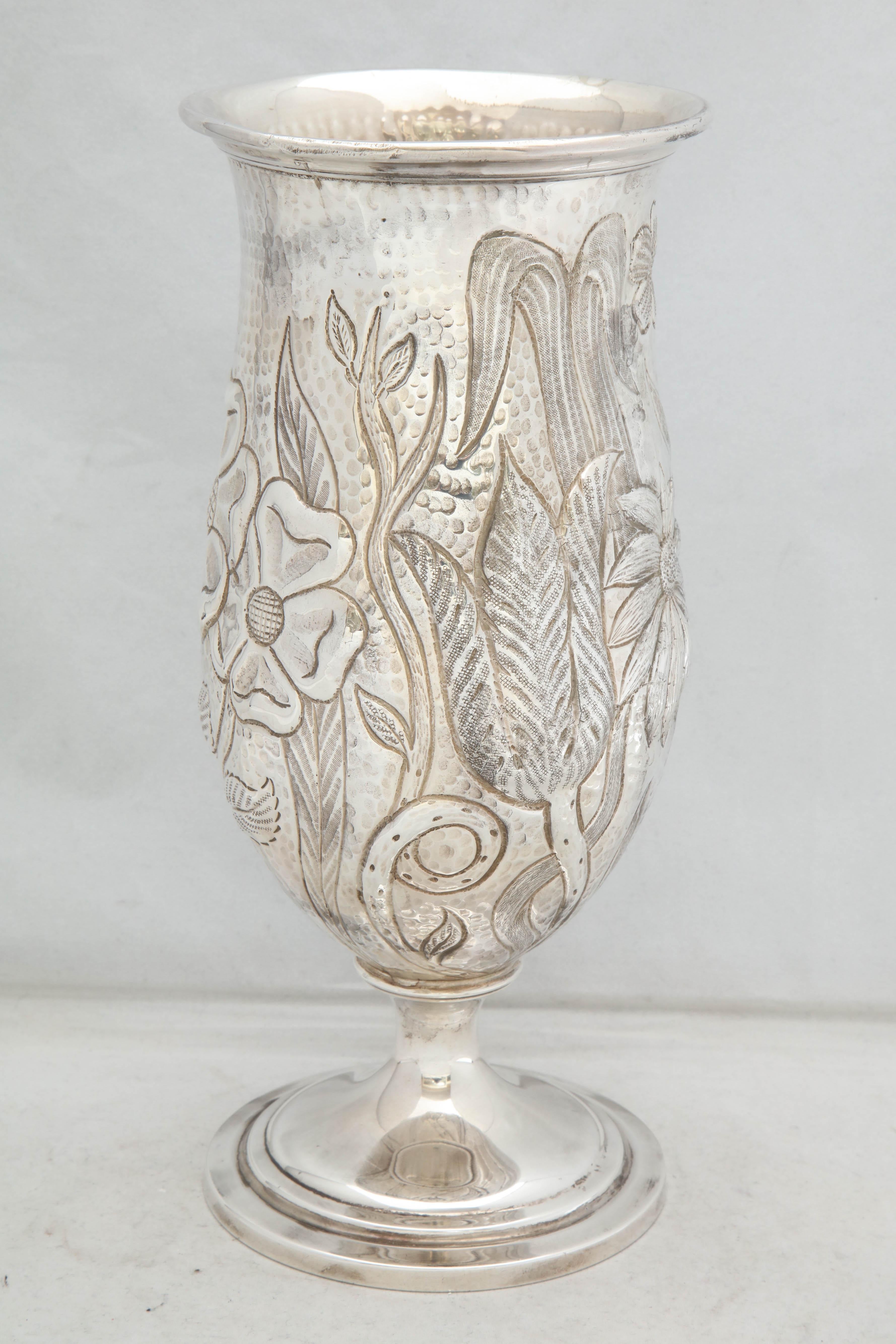 Art Nouveau-Style, sterling silver, pedestal-based vase, Gorham Mfg. Company, Providence, Rhode Island, year-hallmarked for 1923. Hammered in design and chased with flowers. Measures: 10 1/2 inches high x 4 3/4 inches diameter across opening x 4 1/2