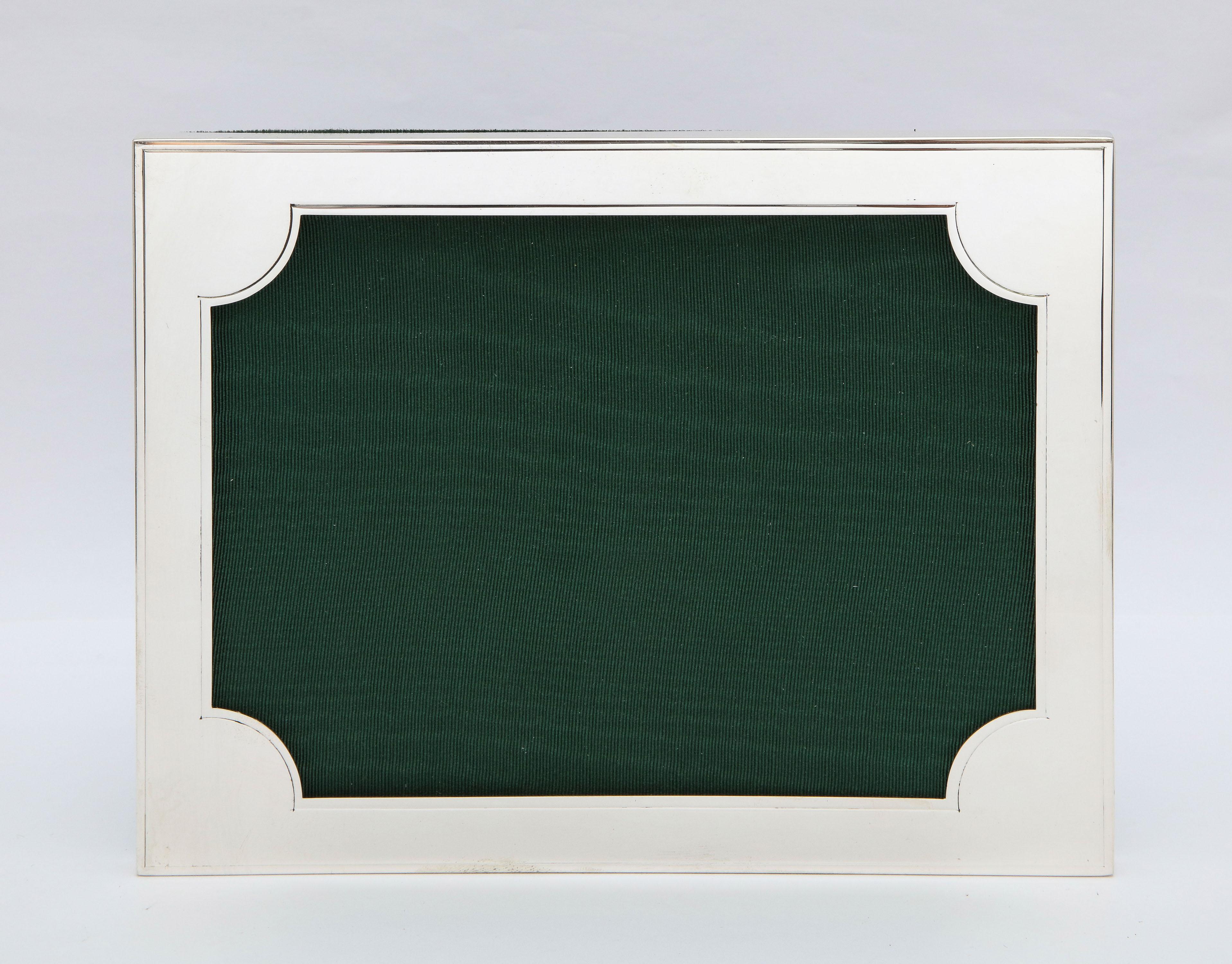 Art Deco, sterling silver picture frame, New York, circa 1930s, Cartier- maker. Measures 8 1/2 inches high x 6 1/4 inches wide x 4 3/4 inches deep when easel is in open position. Stands both horizontally and vertically. Will show a photo that is 5