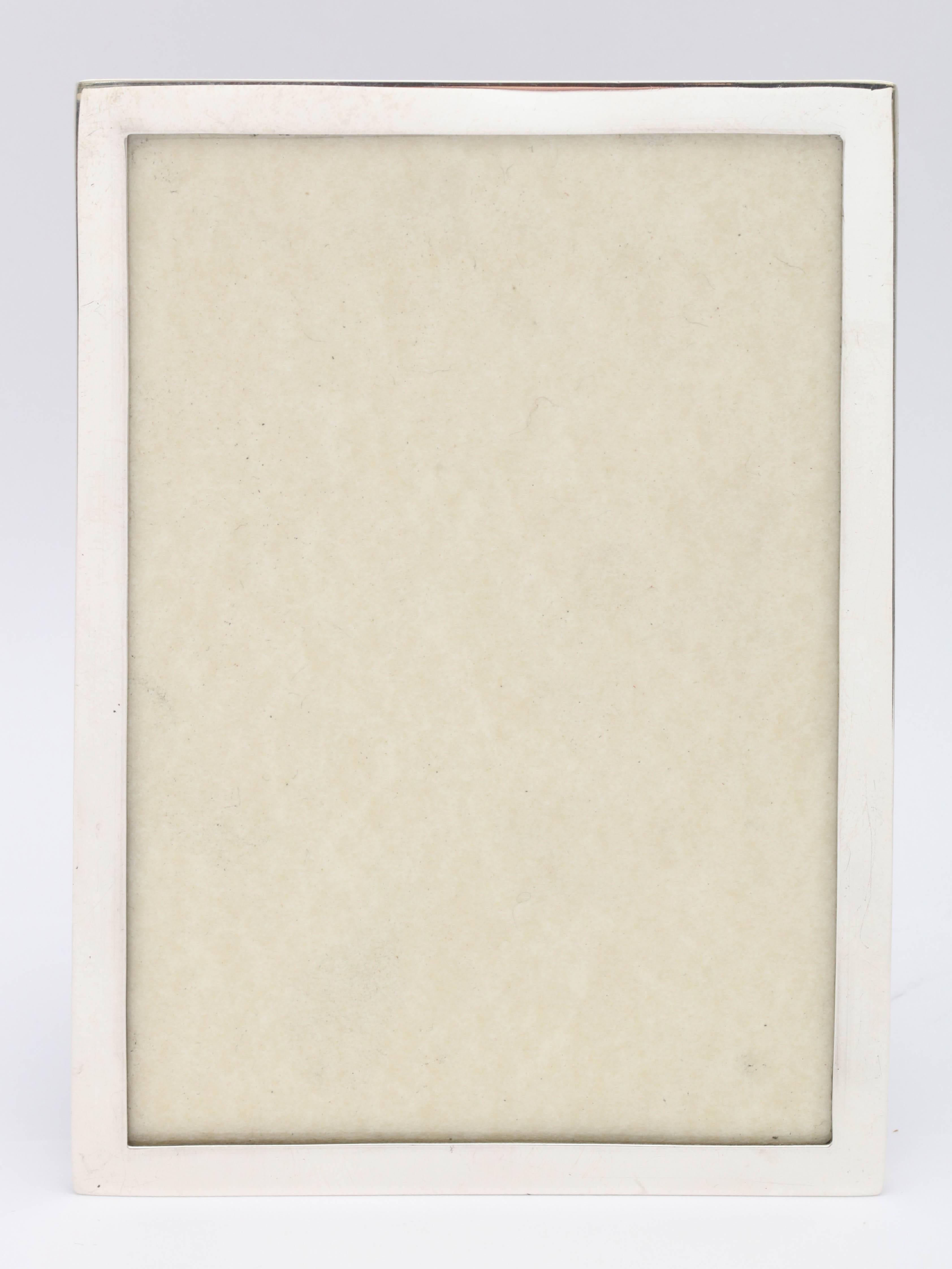 Art Deco, sterling silver picture frame with wood back, Birmingham, England, Horton and Allday - makers. Measures 5 3/4 inches high x 4 1/4 inches wide x 3 1/4 inches deep when easel is in fully open position. Shows a photo that measures 3 1/2