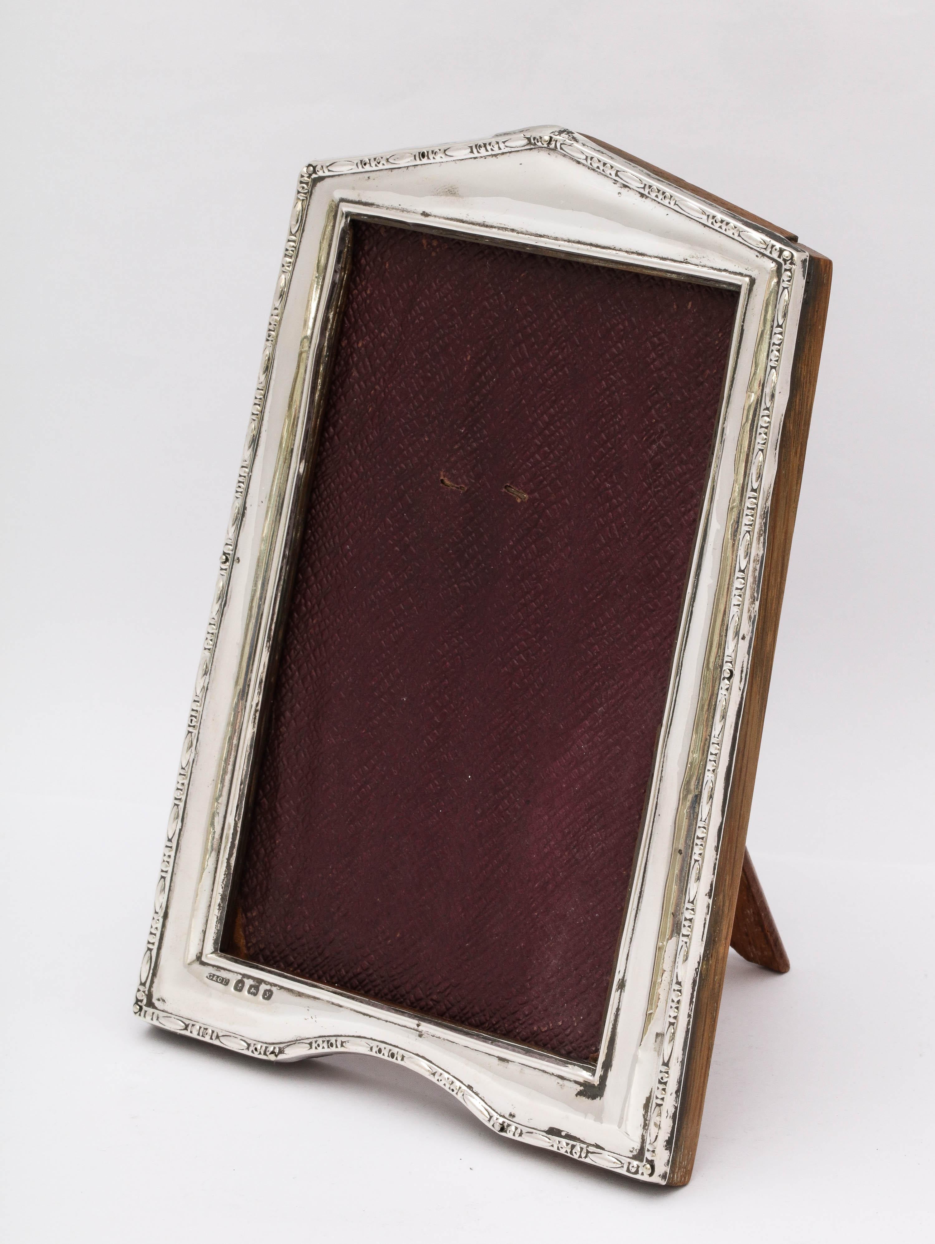 Art Deco, sterling silver picture frame with wood back, Birmingham, England, 1923, Gulienetti and Co., Ltd. - makers. Measures 6 1/2 inches high (at highest point) x 4 1/2 inches wide (at widest point) x 3 1/2 inches deep) when easel is in open