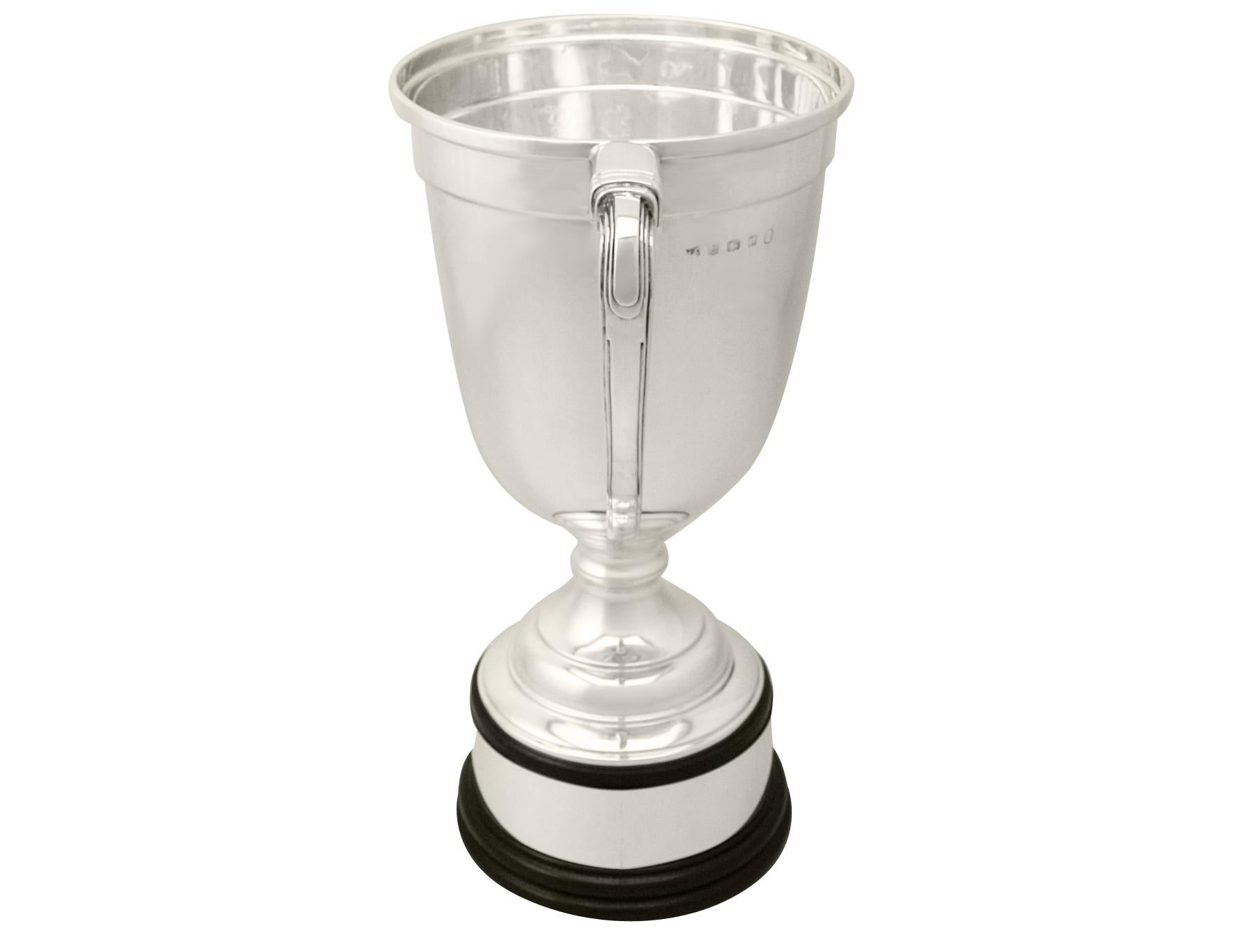 A fine and impressive antique George V English sterling silver presentation cup in the Art Deco style; an addition to our presentation silverware collection

This fine antique George V sterling silver presentation cup has a plain bell shaped form