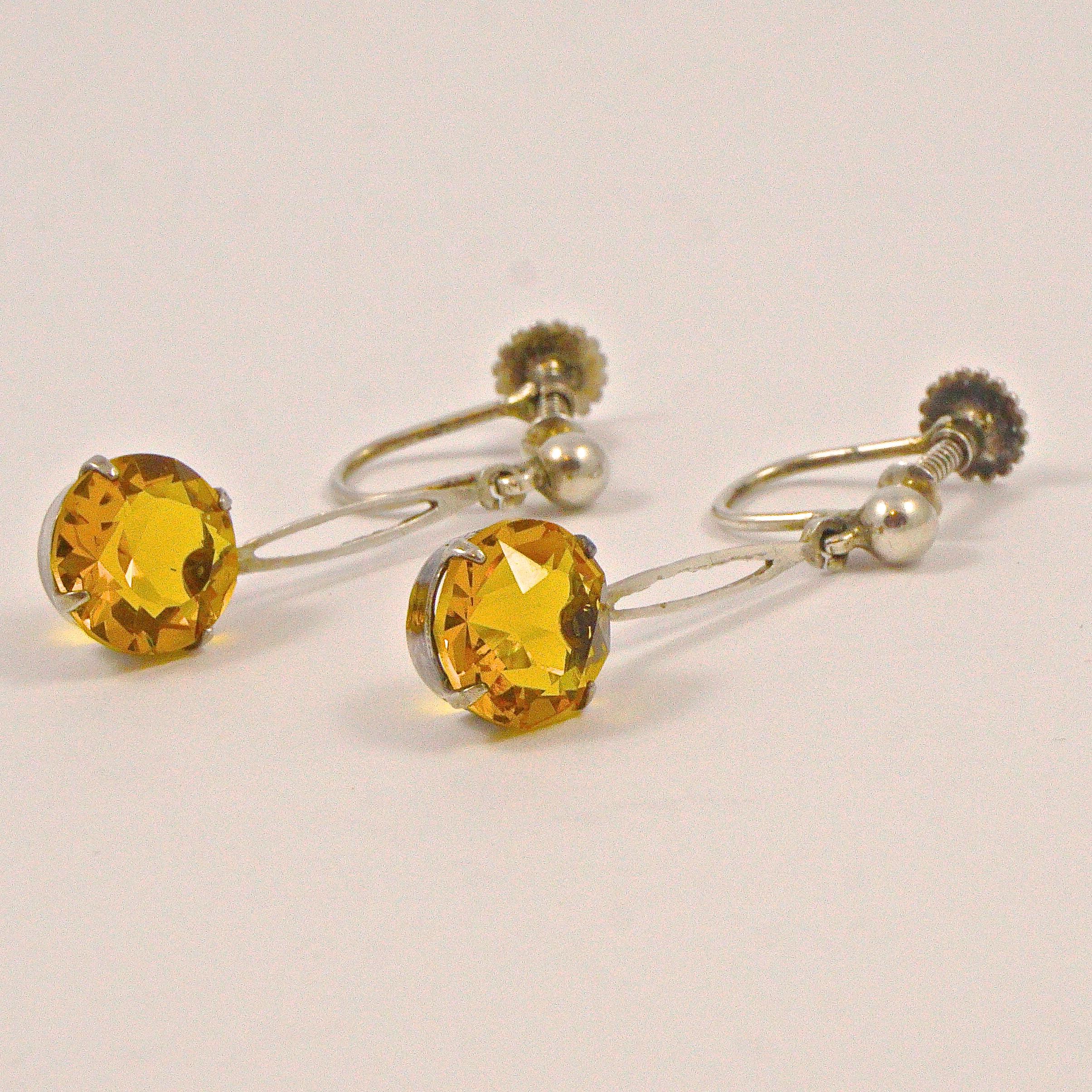 Stylish Art Deco sterling silver earrings set with faux citrine faceted glass drops, and screw back fittings. Measuring length 2.8cm / 1.1 inches, and the drops are diameter 8mm / .31 inch. The lovely sparkling faux citrines are open back to catch
