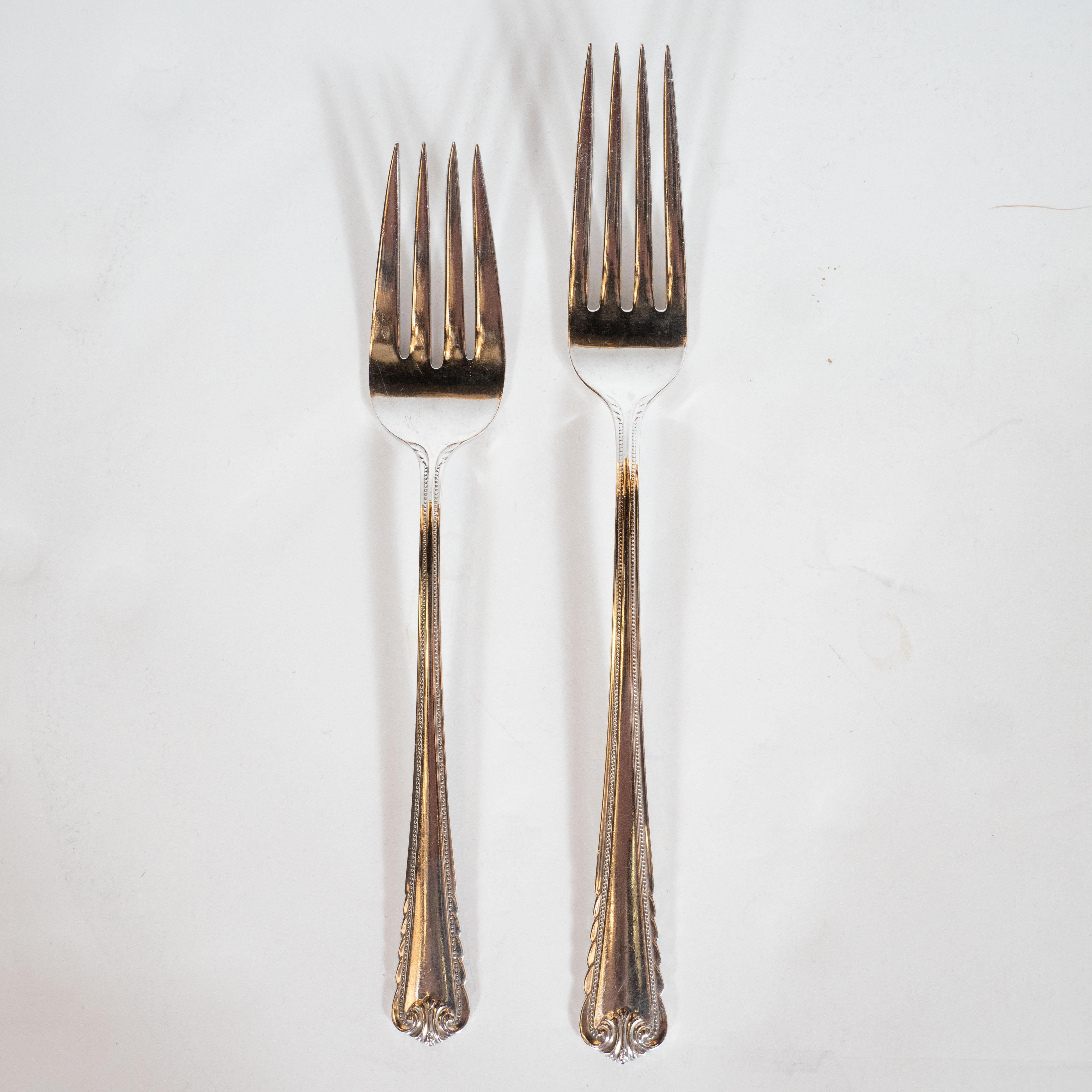 This beautiful Art Deco sterling silver set, realized in a modernist neoclassical style, is a complete set for eight guests, including eight of the following: knives and forks as well as soup spoons, butter knives, salad forks, and tea spoons. All