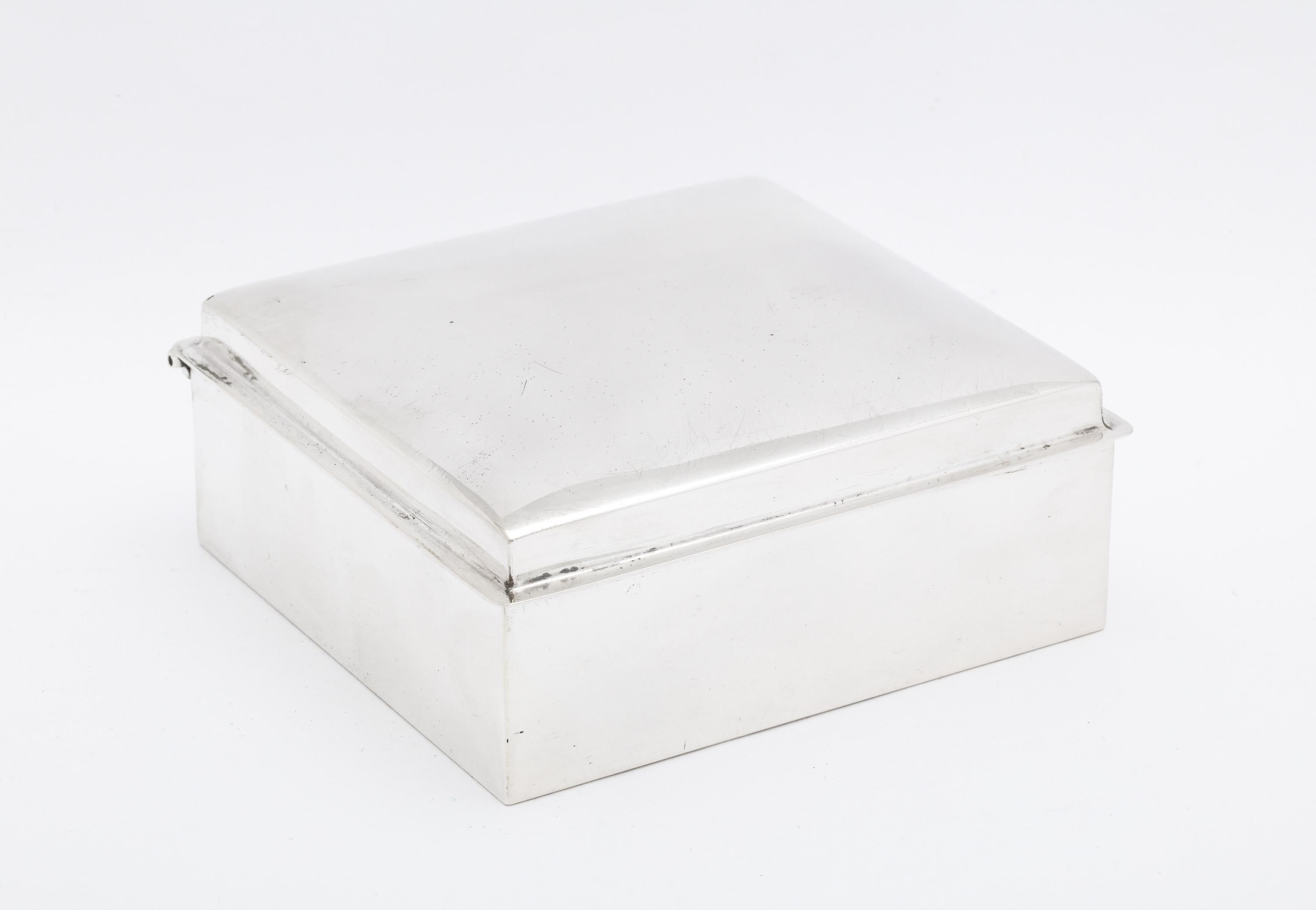 Art Deco, sterling silver table box with hinged lid, Fisher Silversmiths, Inc., New Jersey, Ca. 1935. Underside of lid is gilded; box is wood-lined. Measures 4 inches deep x 3 3/4 inches wide x 1 1/2 inches high. Minor scratches on underside and has