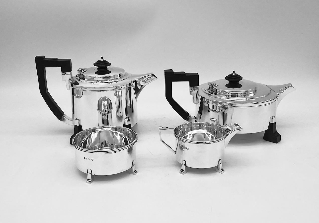 A rare and unusual sterling silver tea and coffee set of art deco design. The four pieces were hallmarked in England between 1935 and 1937, and the squat round form is complemented on each piece by four angular feet, made of silver on the sugar bowl