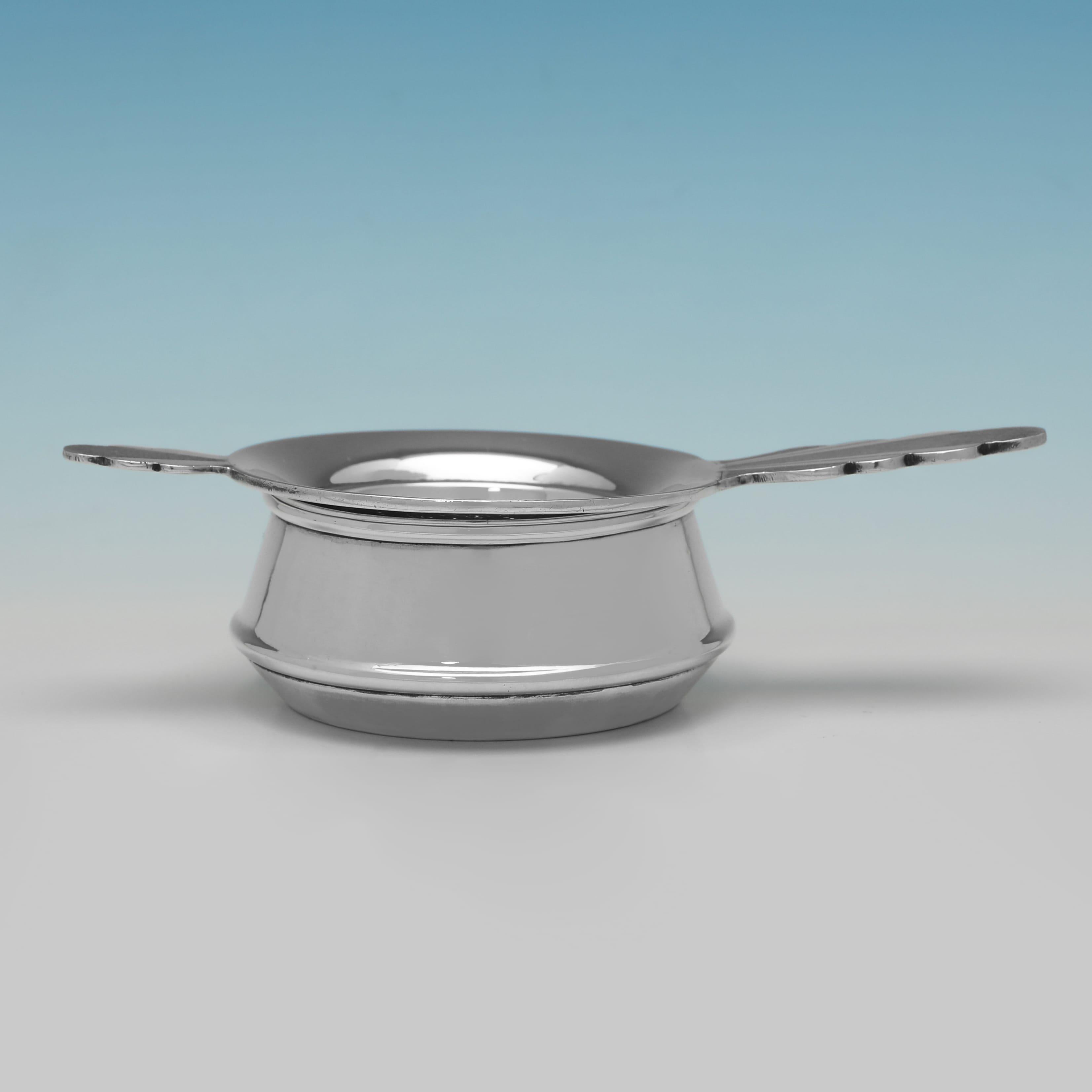 Hallmarked in Birmingham in 1948 by Sanders & Mackenzie, this stylish, George VI period, Sterling Silver Tea Strainer, is in the art deco taste. The tea strainer measures 1.25