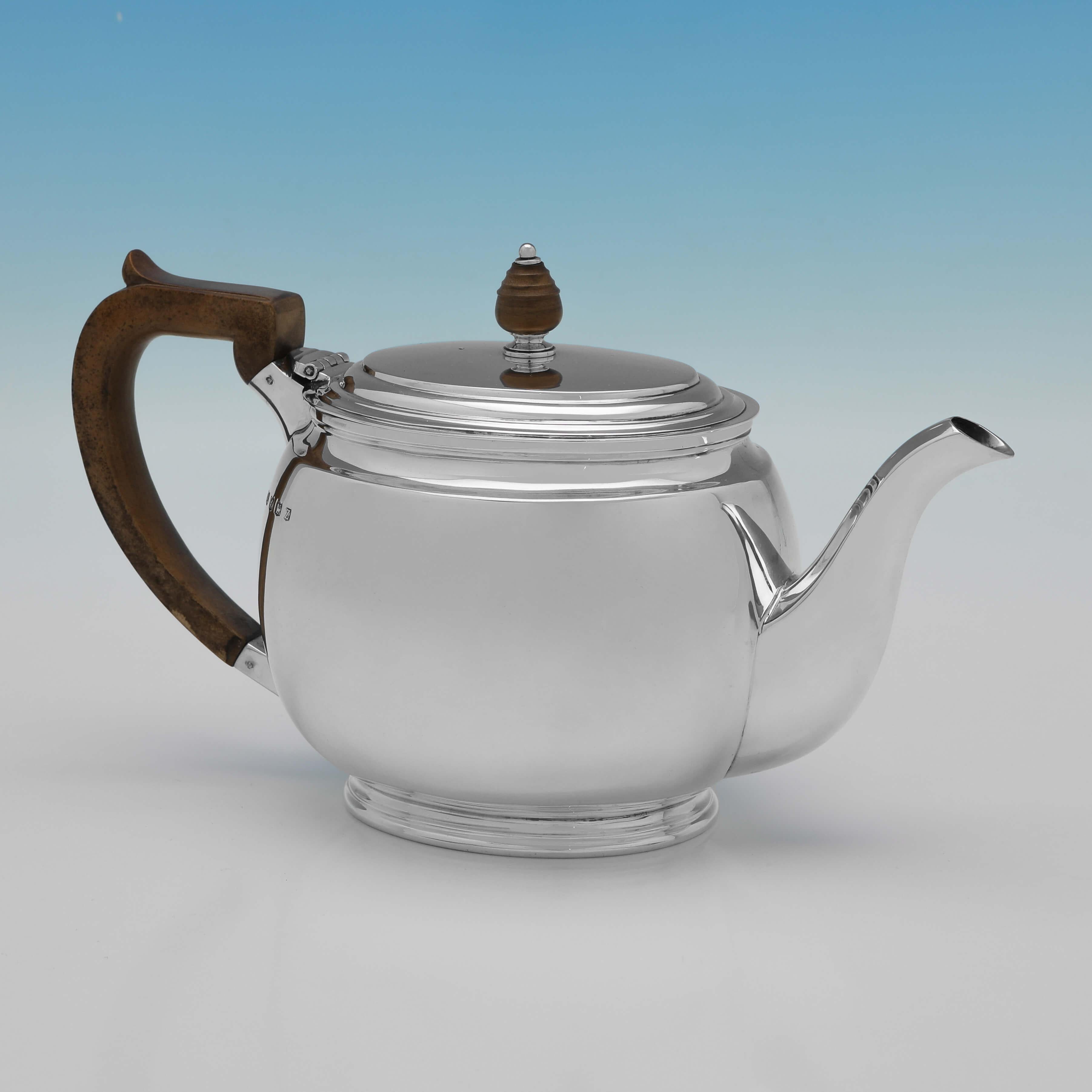Hallmarked in Sheffield in 1942 by William Suckling Ltd., this handsome, Sterling Silver Teapot, is in the Art Deco taste, and measures 6