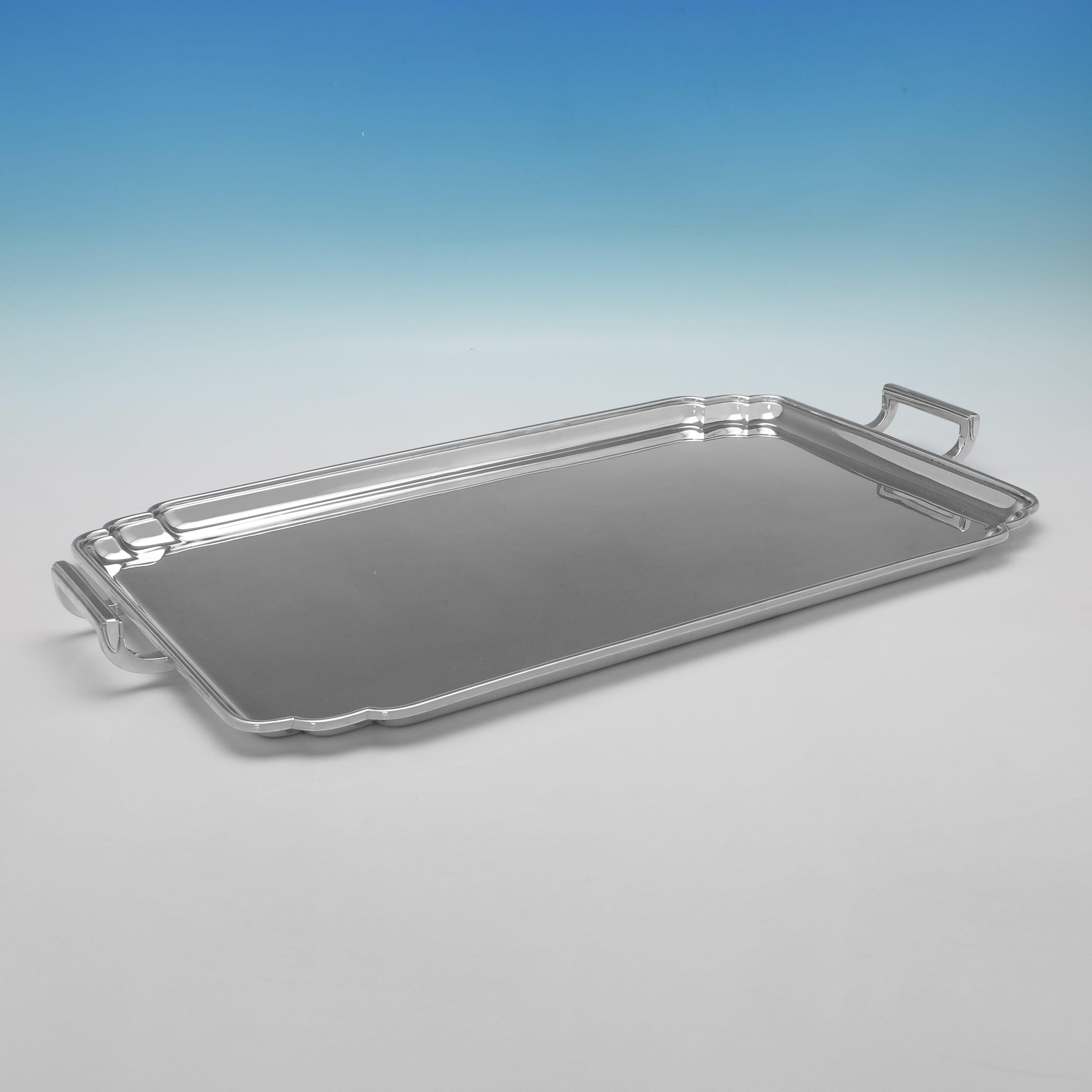 Hallmarked in Sheffield in 1944 by Frank Cobb & Co., this handsome, George VI period, Sterling Silver Tray, is in the art deco taste, with shaped corners and reed detailing. The tray measures 1.5