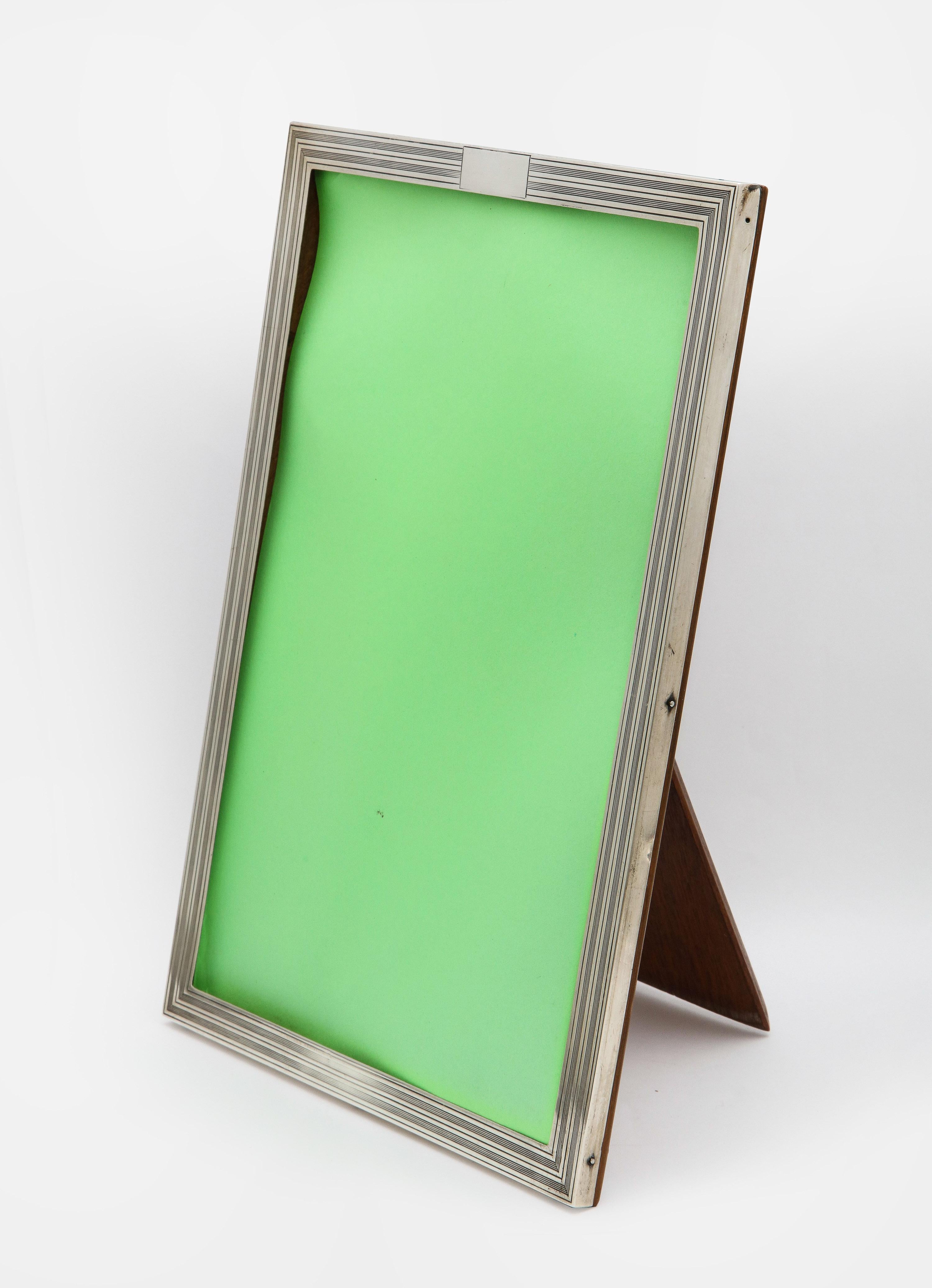 Art Deco, sterling silver, tuxedo-striped picture frame with wood back, Birmingham, England, year-hallmarked for 1925, Charles S. Green and Co., Ltd. - makers. Vacant cartouche. Measures 10 3/4 inches high x 7 1/2 inches wide x 7 1/4 inches deep