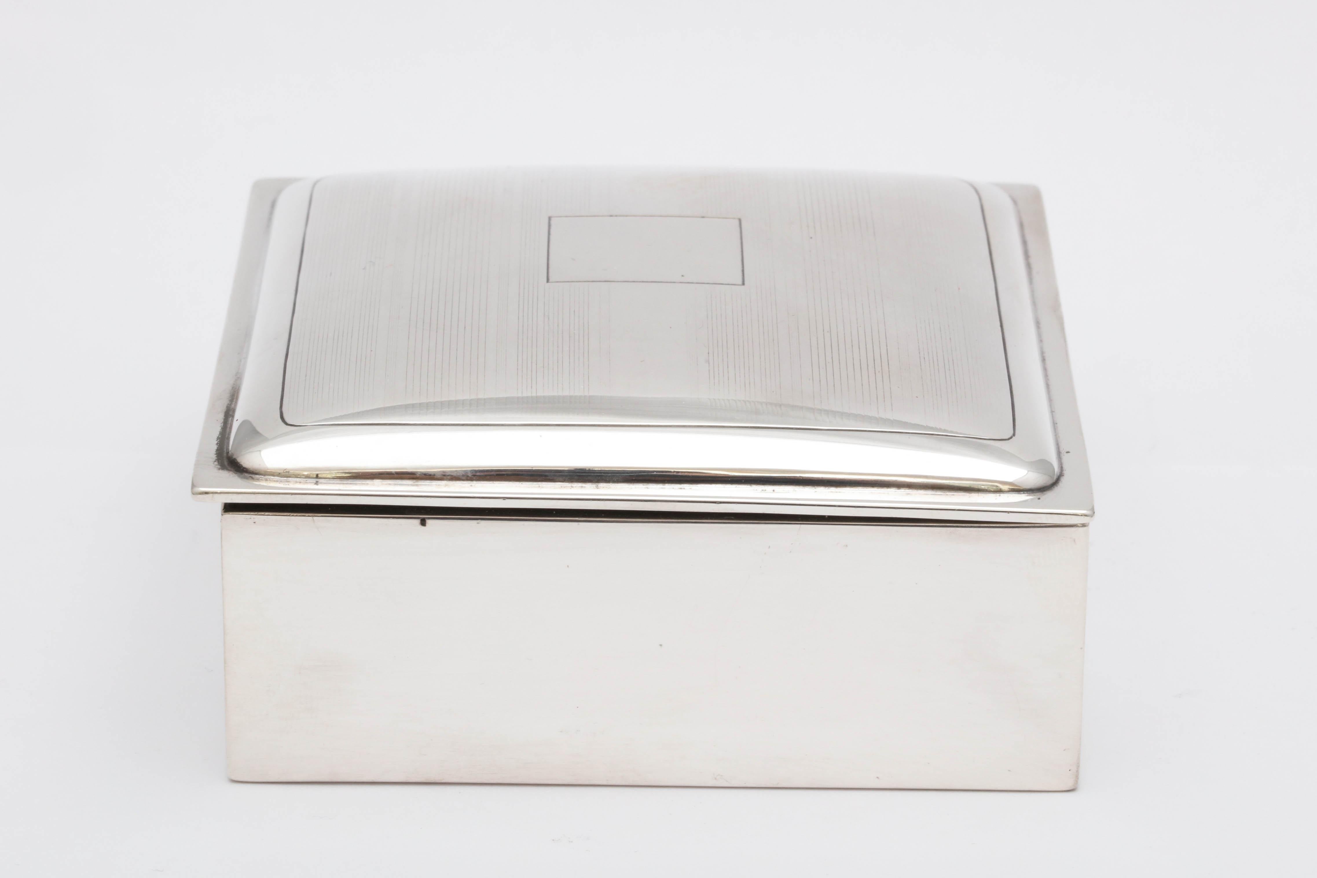 Art Deco, sterling silver, tuxedo striped table box with hinged lid, James E. Blake Co., Attleboro, Mass., circa 1910. Wood lined. Vacant cartouche. Underside of lid is gilded. Box is wood lined. Measures: 3 3/4 inches wide x 3 3/4 inches deep x 1