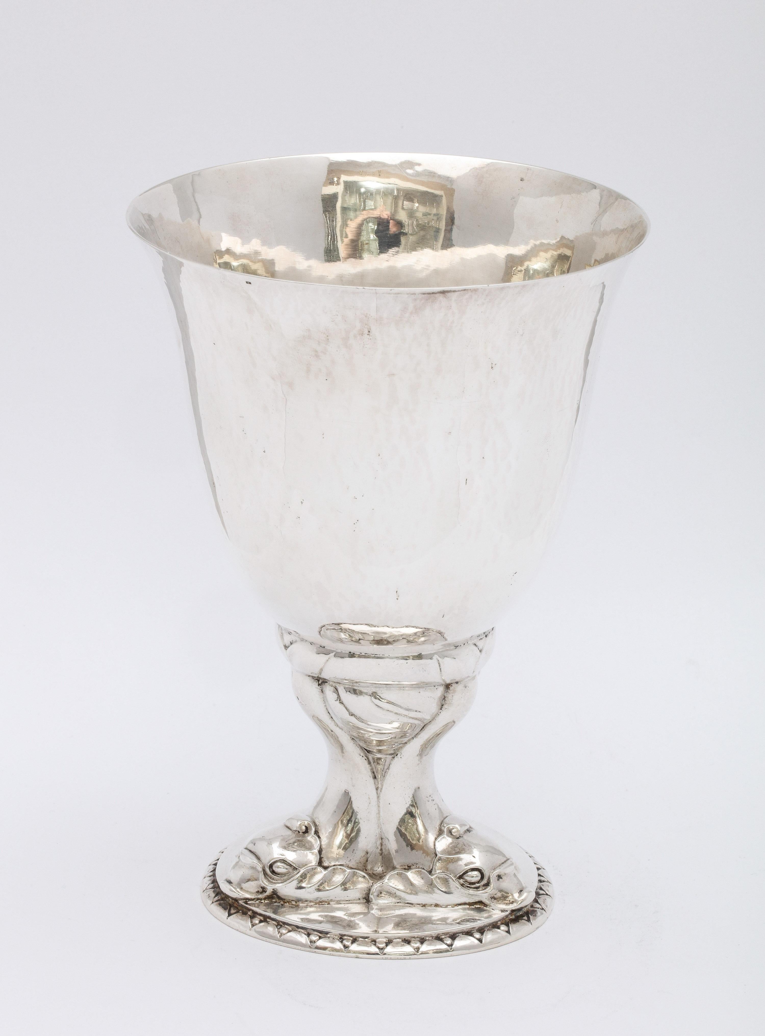 Art Deco, sterling silver vase, Denmark, year-hallmarked for 1919, Georg Jensen - maker. Ovoid shaped base is composed of three dolphins. Sterling silver is lightly hammered. Vase measures 6 1/4 inches high x almost 4 1/2 inches diameter across
