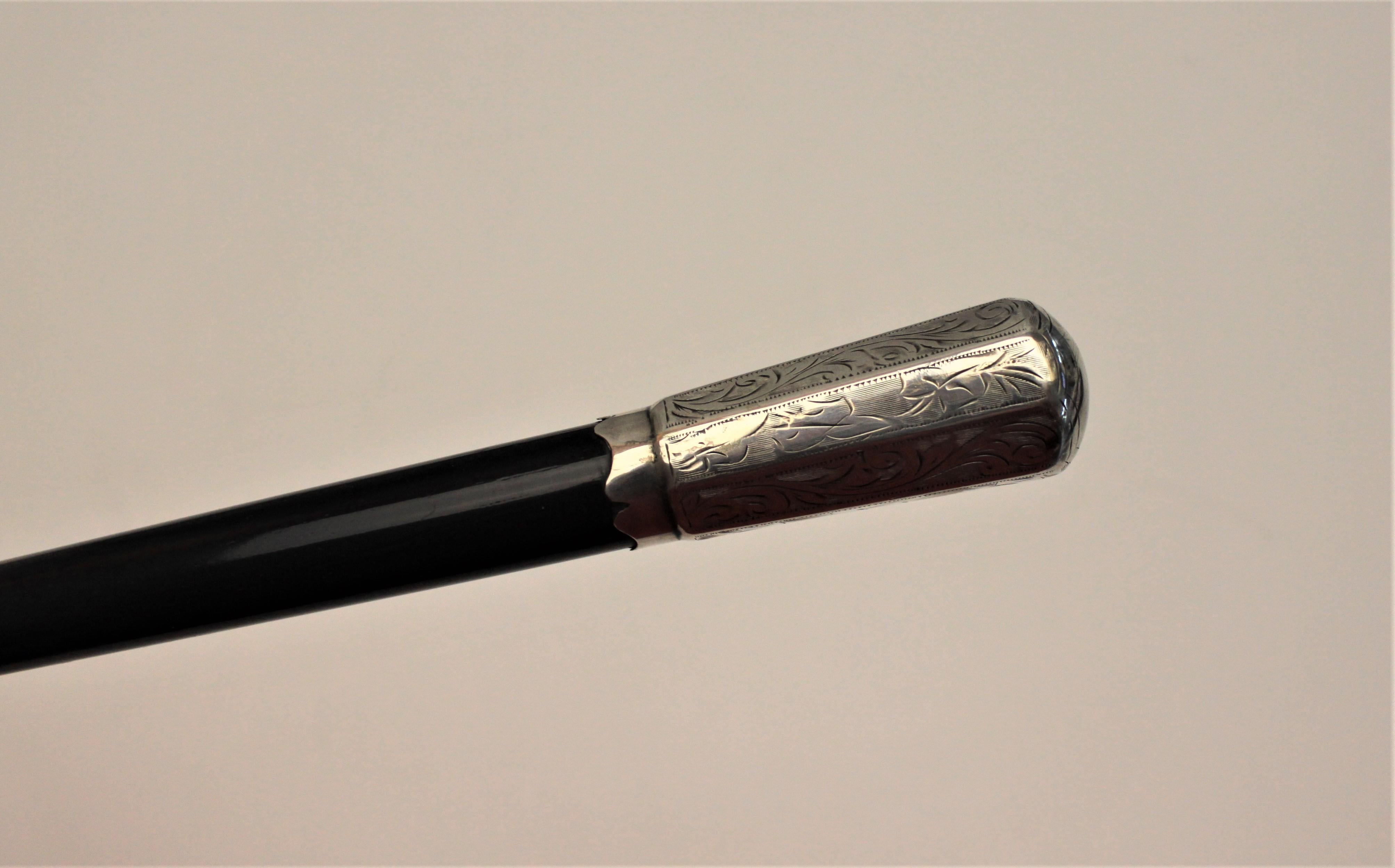 This conductor's baton was made in England in circa 1927 in the period and style of Art Deco. The baton is composed of ebonized wood with sterling mounts. All three sterling mounts are intricately engraved and bear the same hallmarks, dating it