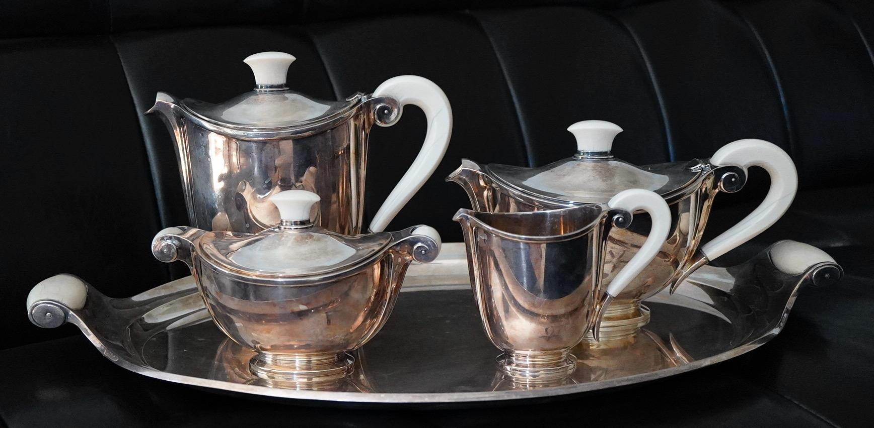 Art Deco sterling tea service and tray with bone handles. Designed in 1936 by Marcel 
Wolfers, and depicted in a book about Wolfers Freres. The service is fully hallmarked for Wolfers Freres and sterling.
The coffee pot is 8 1/2