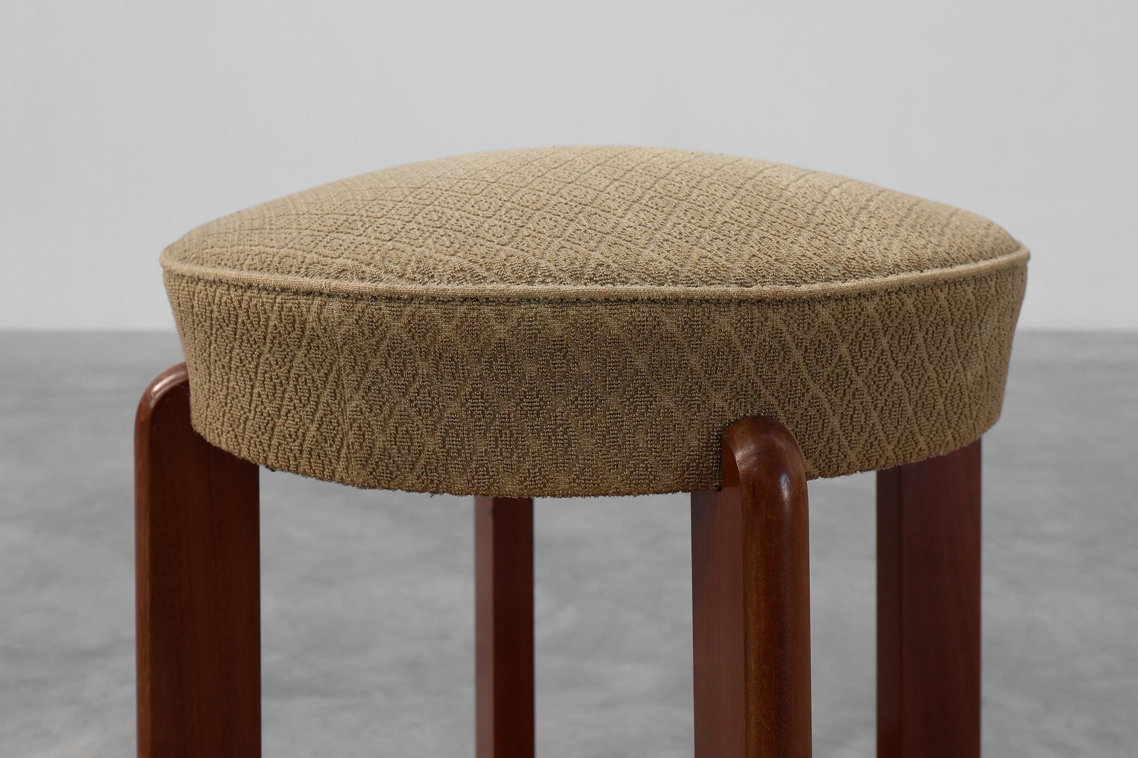 France / 1920 / stool / wood, fabric / Art Deco 

Beautiful Art Deco stool with original upholstery on the seat and a platform underneath. This comfortable round stool has a soft seat covered in the original beige fabric with a subtle geometric