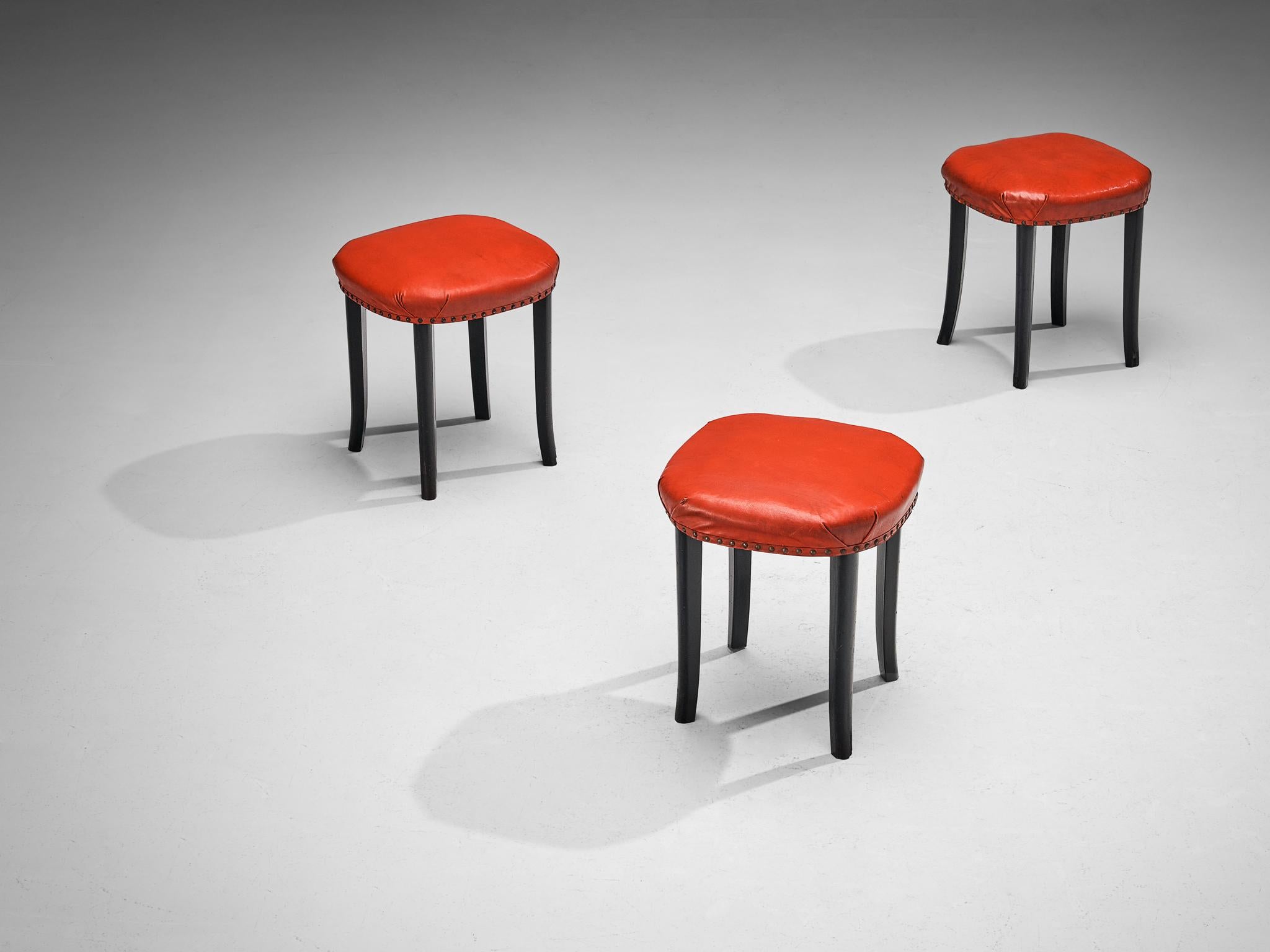  Stools, faux leather, metal, stained beech, Europe, 1930s

Set of three stools made in Europe in the Art Deco period. These stools are interesting in their design due to the square shape the seats show. The items are upholstered in a bright red