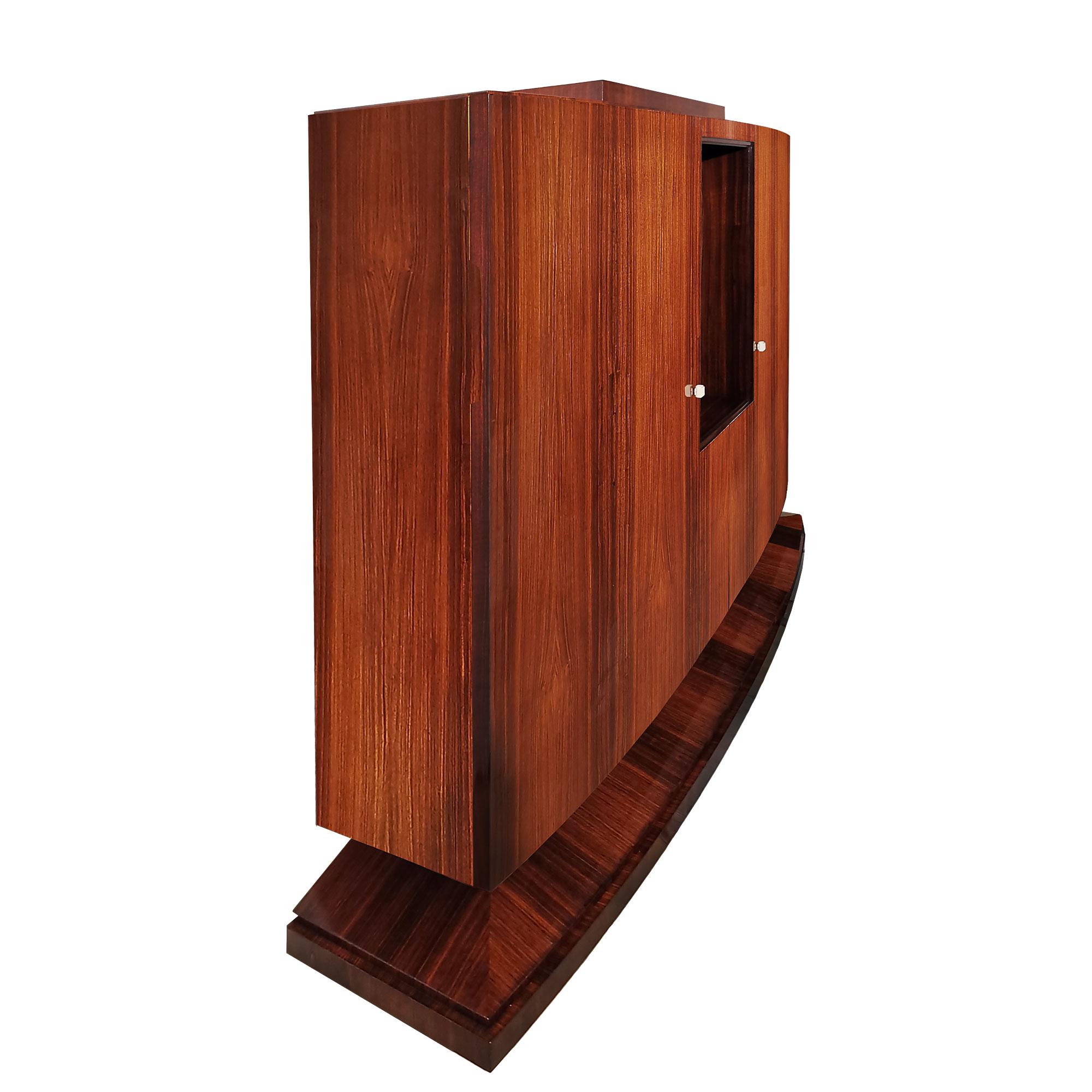 Extraordinary Art Deco storage cabinet-bookcase, solid mahogany with mahogany veneer outside and sycamore inside with a wide base, french polish. Two curved doors with shelves inside and a space for strongbox, nickel plated metal hinges and locks,