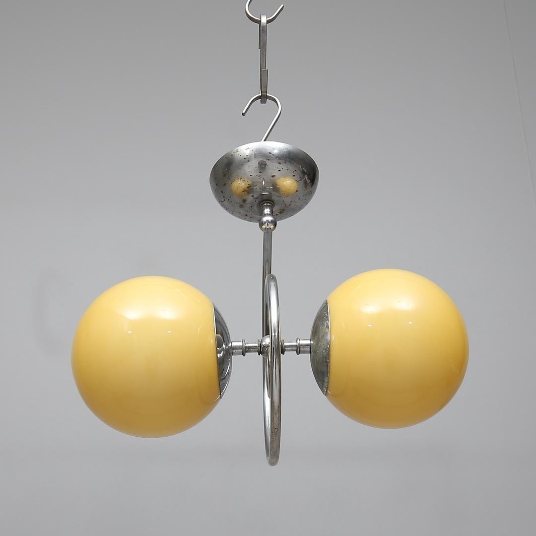 Art Deco chandelier with a nickel-plated brass frame, glass shade. Manufactured in Sweden in the 1930s and attributed to Böhlmarks Lampfabrik.
The length will be customized on request.
 