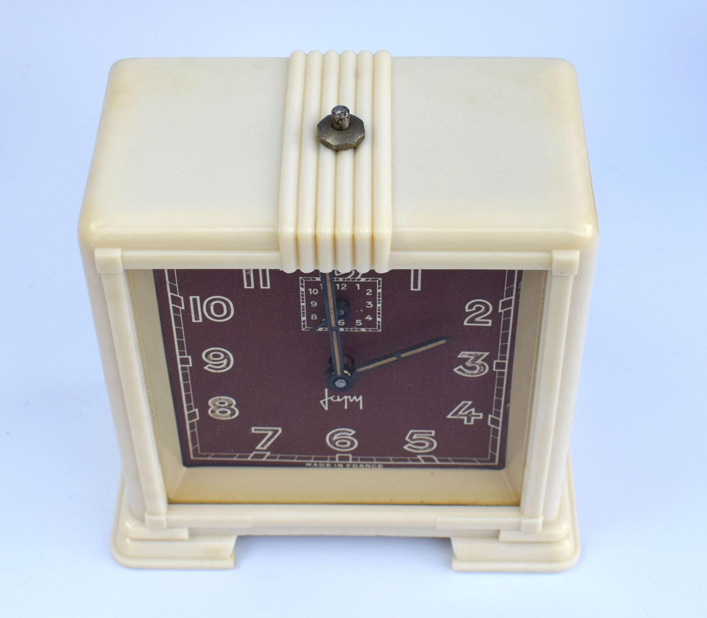 Lovely Art Deco French clock by the French clock makers Japy. Streamline bakelite casing with maroon colored dial. Fully serviced and keeping good time.