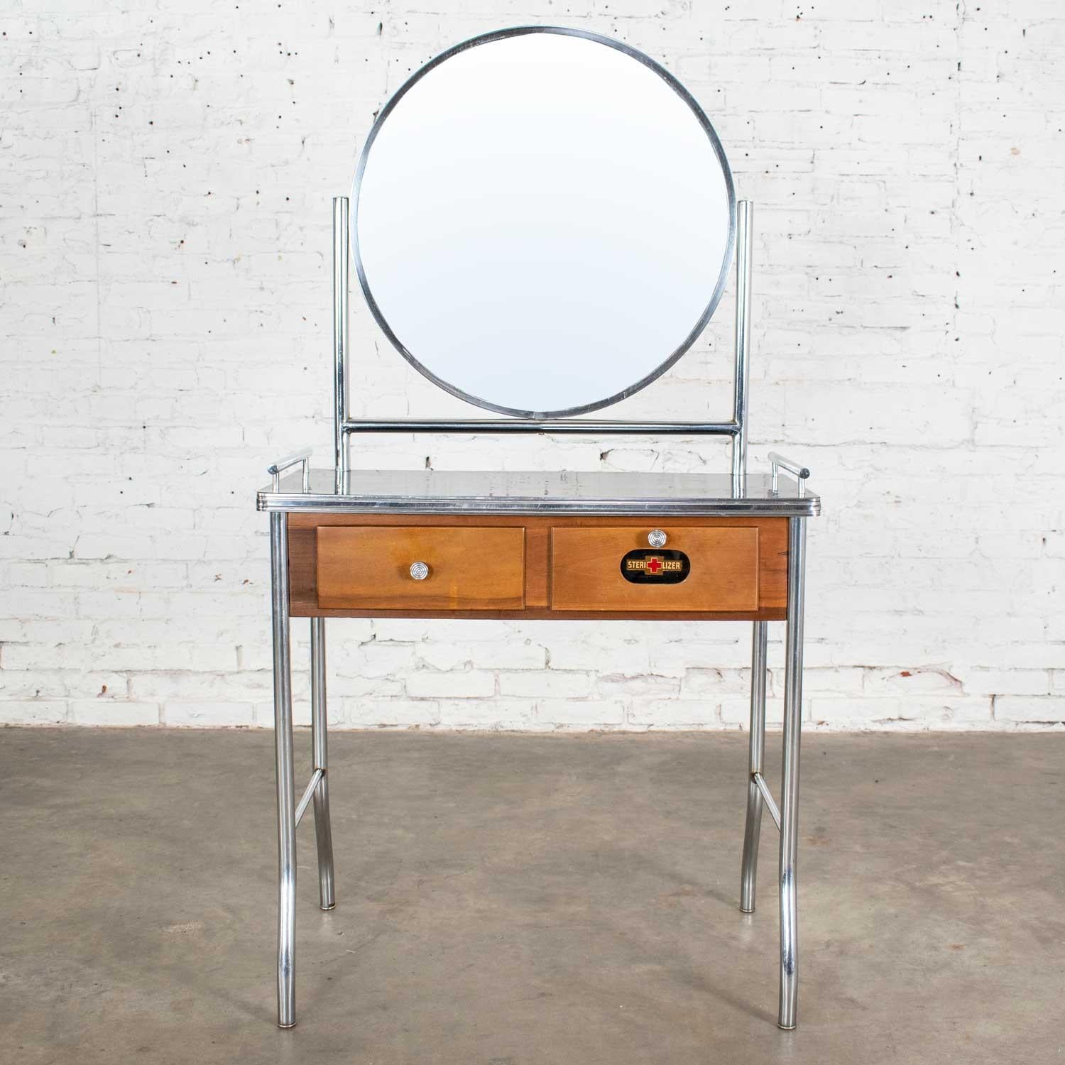 Fabulous Art Deco, Streamline Modern, Machine Age, Art Moderne, International style, or Bauhaus make up vanity in chrome and maple with a black top which is possibly made of one of these three materials: Fabrikoid, Bakelite, or Cat-O-Lite (Catalin).