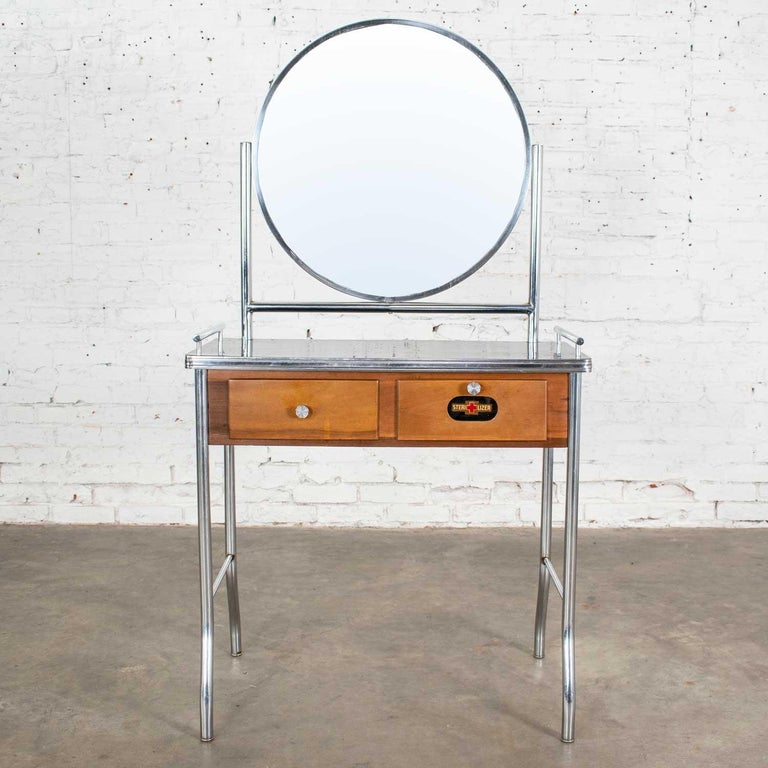 Fabulous Art Deco, Streamline Modern, Machine Age, Art Moderne, International style, or Bauhaus make up vanity in chrome and maple with a black top which is possibly made of one of these three materials: Fabrikoid, Bakelite, or Cat-O-Lite (Catalin).