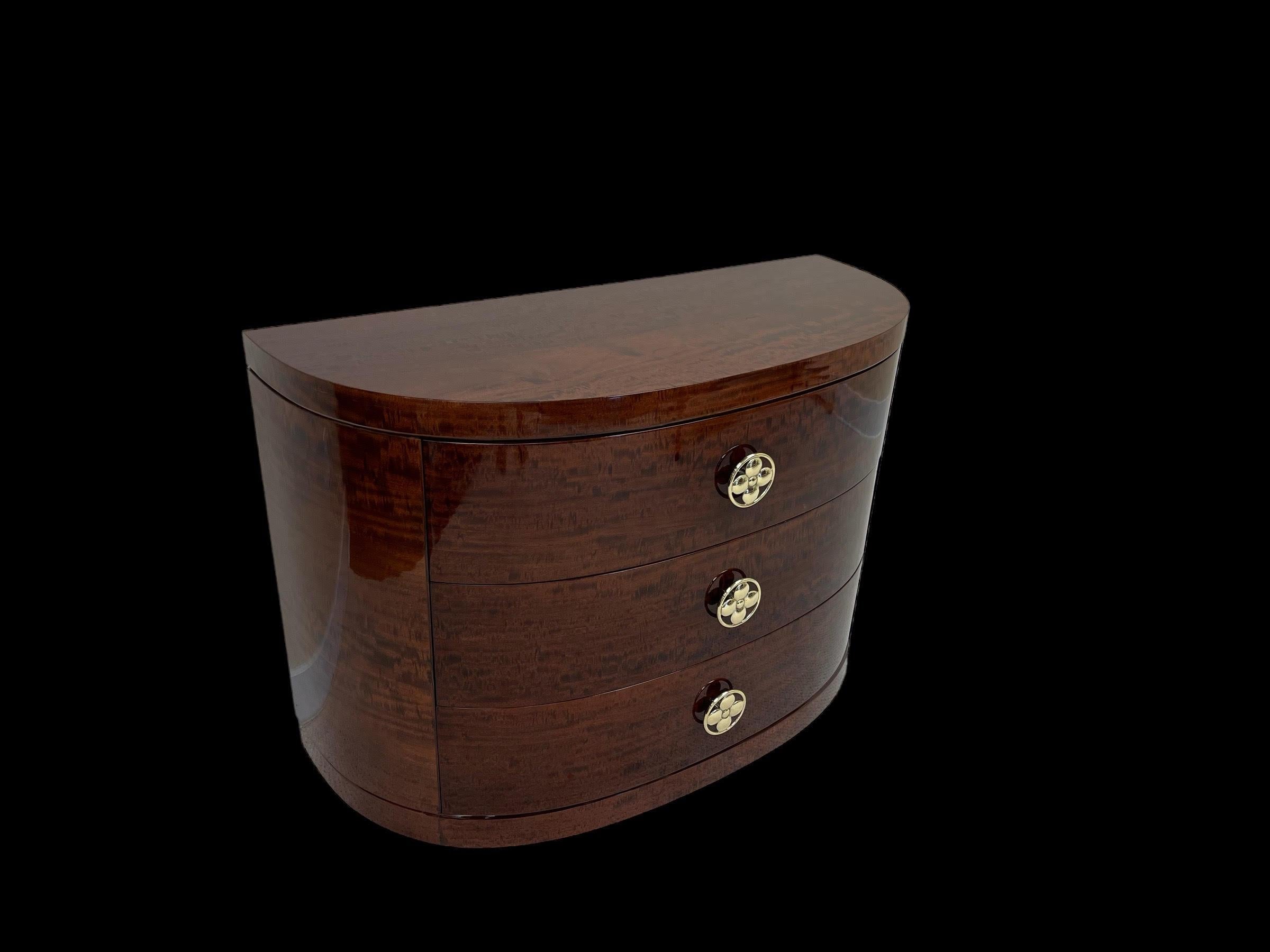 Beautiful Art Deco half circle chest of drawers by the Redlion Furniture Company. In the style of Gilbert Rohde and Donald Deskey. Incredible polished brass handles with a circular flower center. Very rare and hard to find a half circle chest of