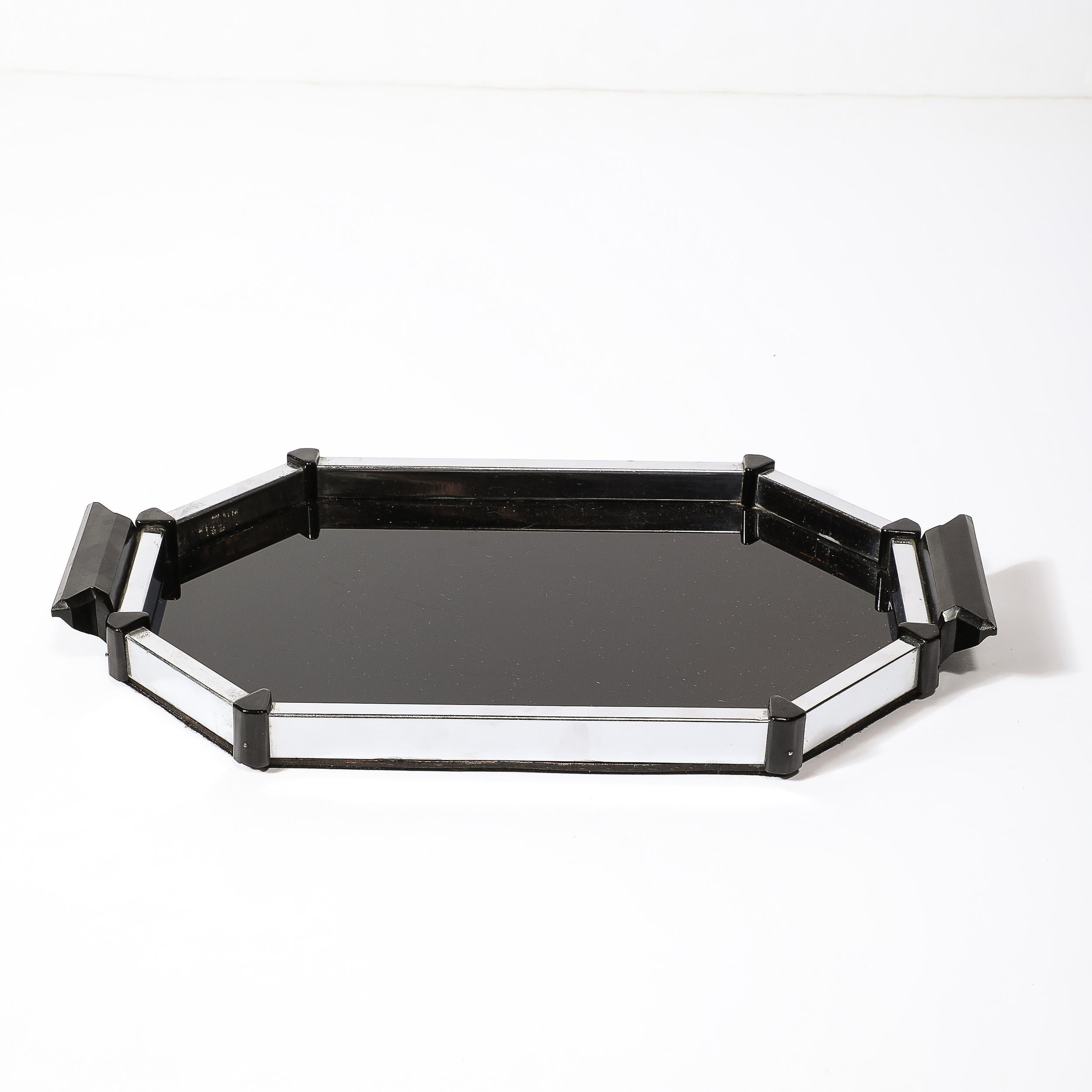 This strikingly geometic Art Deco Streamline Octagonal Chrome and Bakelite Serving Trayoriginates  from the United States, Circa 1935. Crafted in black bakelite for the surface, corner attachments, and handles, with a rectilinear chrome lip