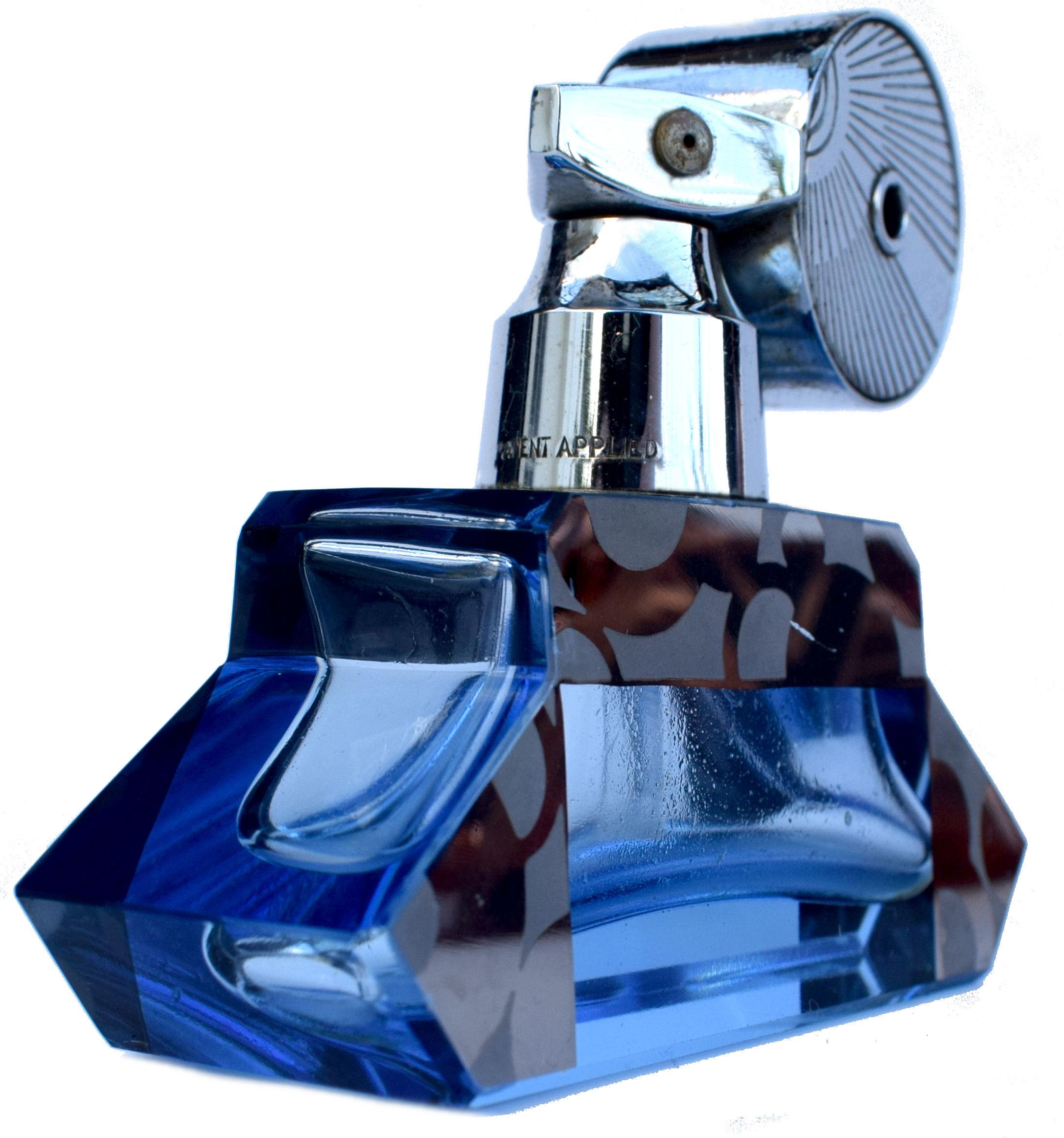 A stylish English 1930s streamline Art Deco atomizer perfume/ scent bottle. Chrome top sprayer with blue glass scent bottle with silver /black enamel decoration to the sides. The neck to the chrome sprayer is marked 'patent pending'. Overall