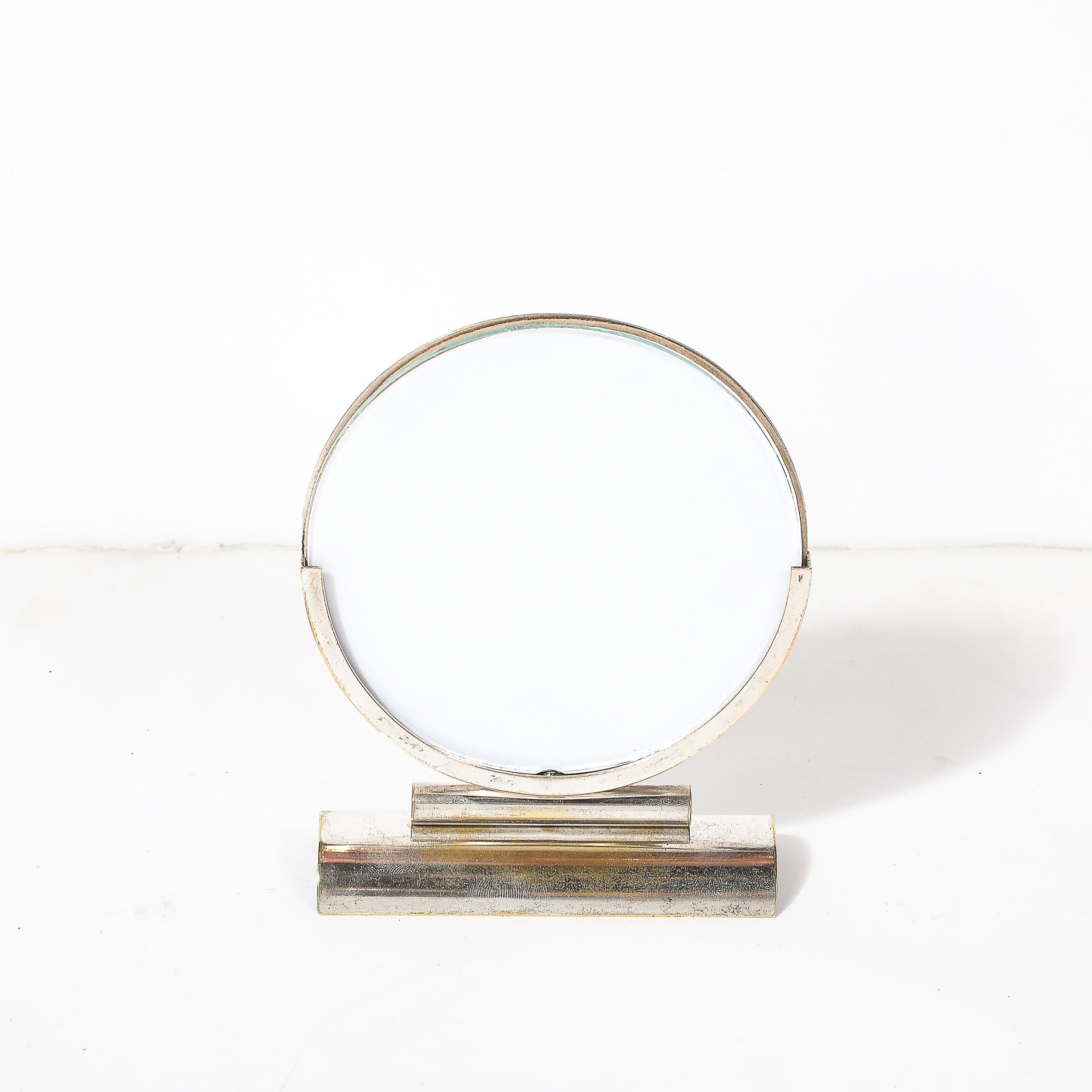 This beautifully crafted Art Deco streamline round picture frame, dating to circa 1930, is a quintessential example of the sleek, modern design principles that defined the era. Made of polished nickel with harmonious curves and a minimalist