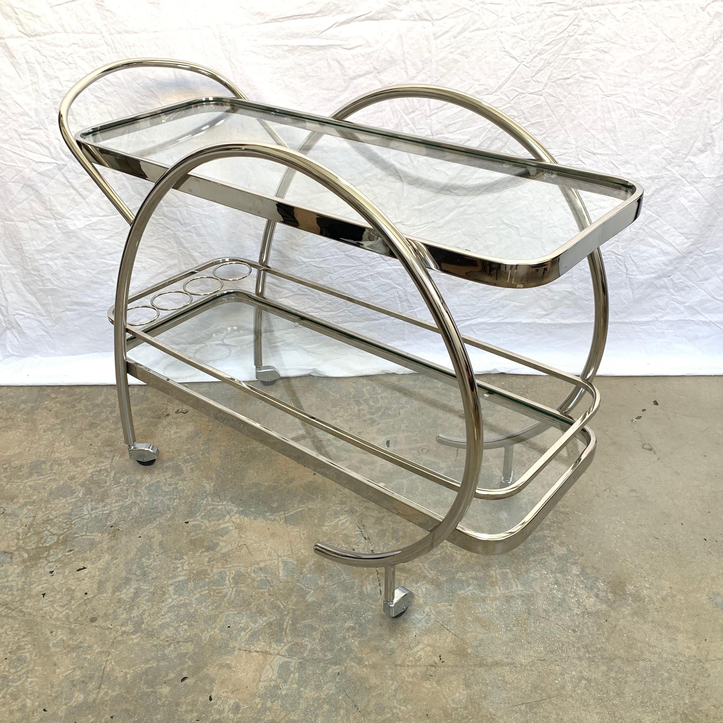 Moderne Art Deco barcart rendered in chrome-plated steel and glass on multidirectional wheels and castors.