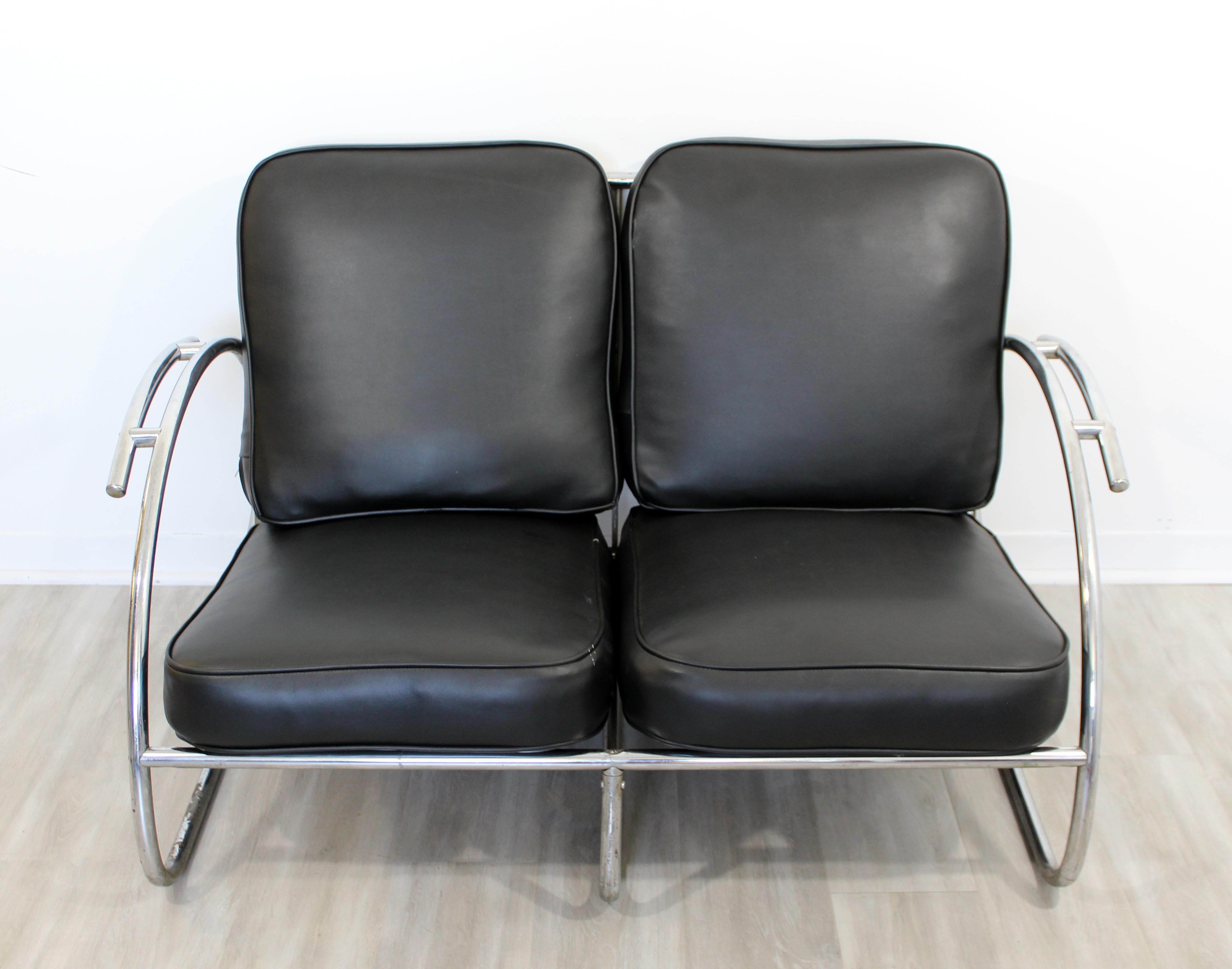 For your consideration is a streamline, Art Deco loveseat, with a chrome base and black vinyl seats, circa 1940s. In very good antique condition. Some of the chrome plating has been worn off. The dimensions are 50