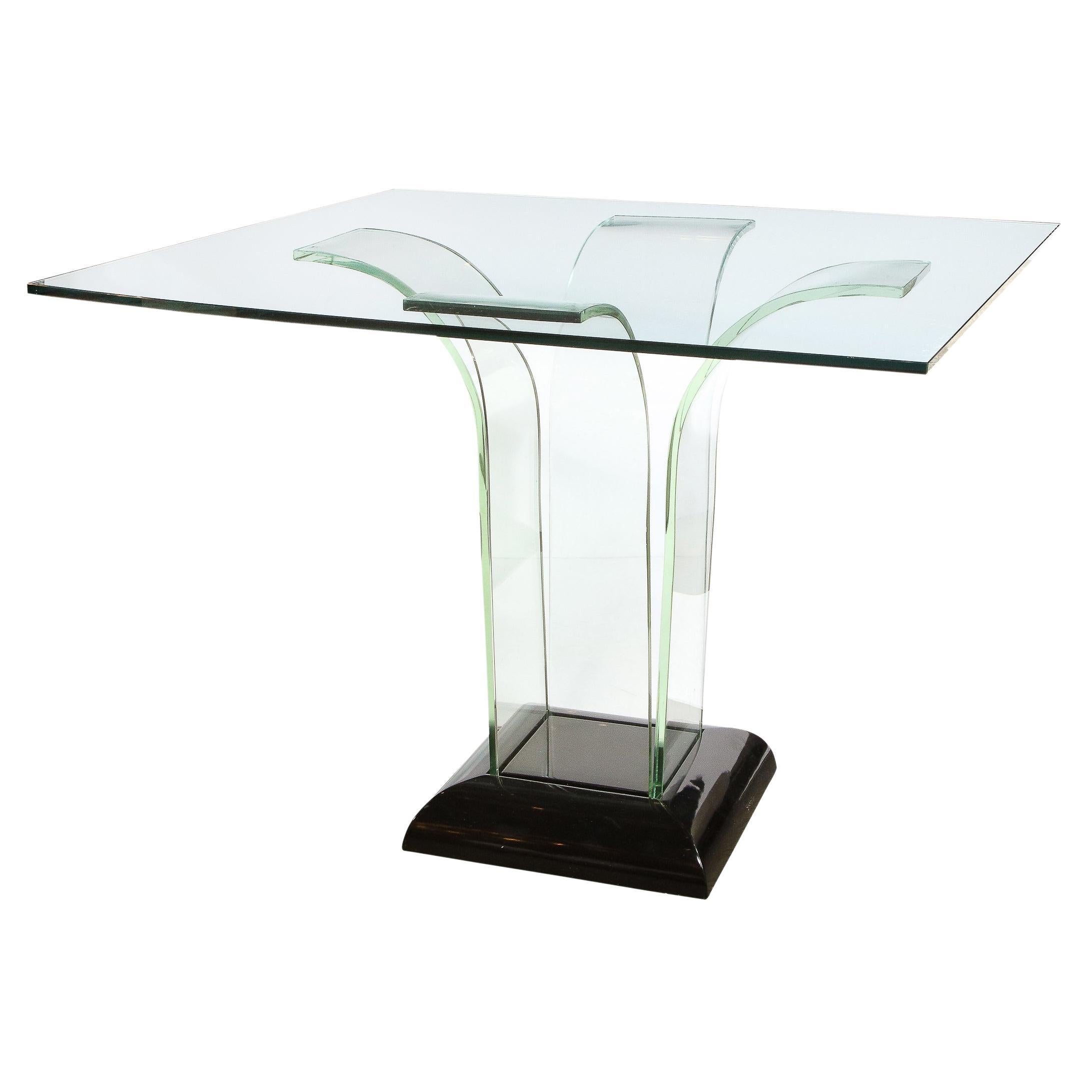 This stunning Art Deco Machine Age game/ dining table was realized in the United States circa 1935 It features a beveled lustrous black lacquer base that supports four streamlined translucent streamlined glass forms that ascend upwards and fan out