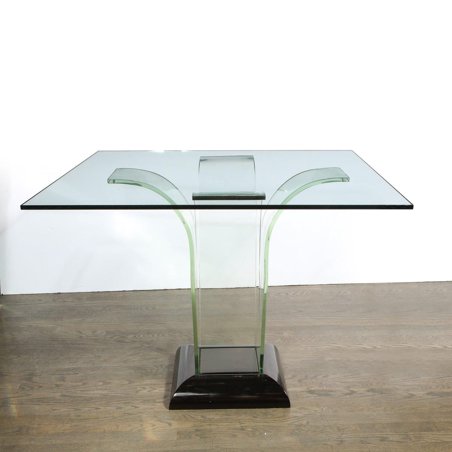 This stunning Art Deco Machine Age game/ dining table was realized in the United States circa 1935 It features a beveled lustrous black lacquer base that supports four streamlined translucent streamlined glass forms that ascend upwards and fan out