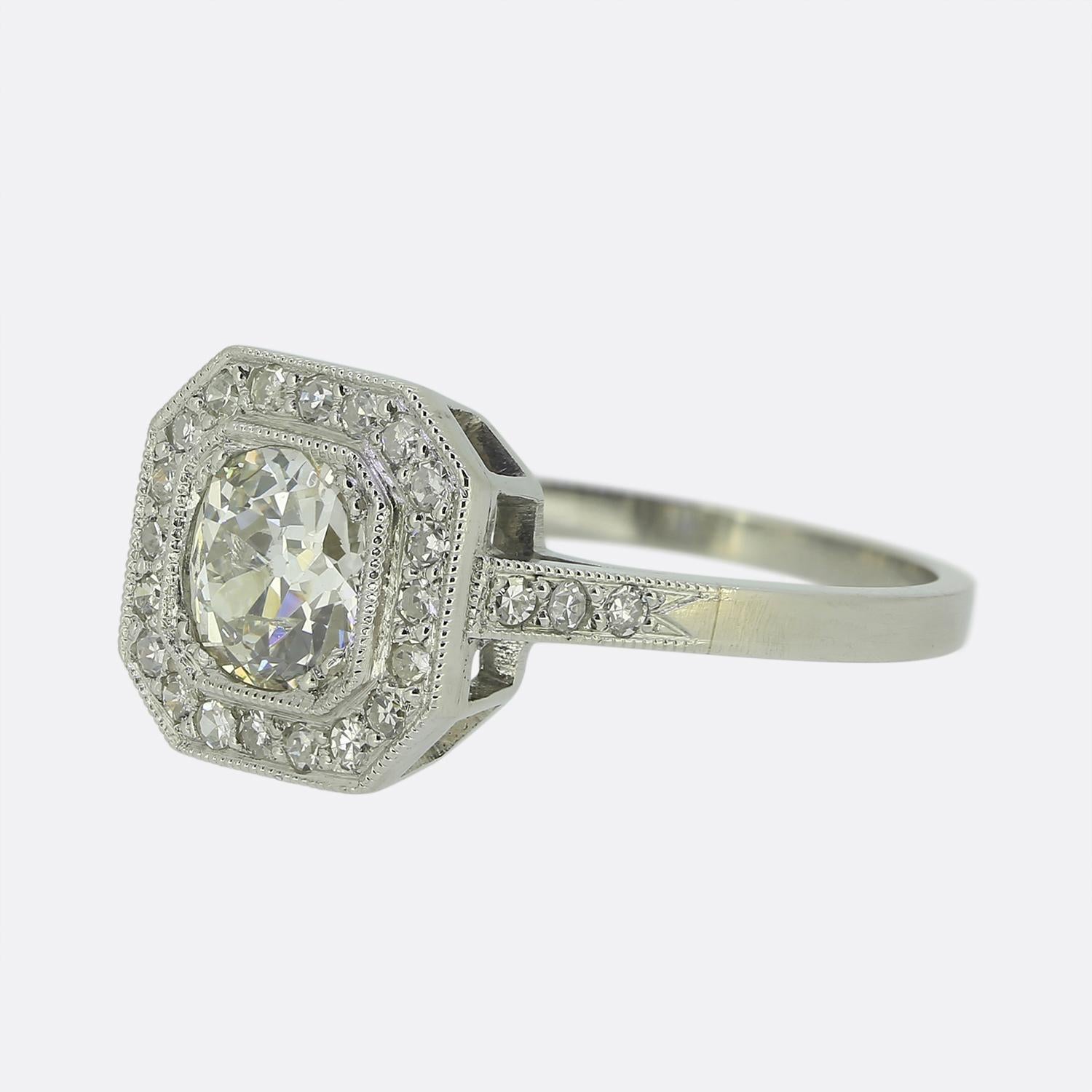 Here we have a classically styled diamond cluster ring. The ring has been excellently crafted from platinum in an Art Deco style and features a stunning 0.75 carat round faceted old mine cut diamond which sits in a claw setting at the centre of the