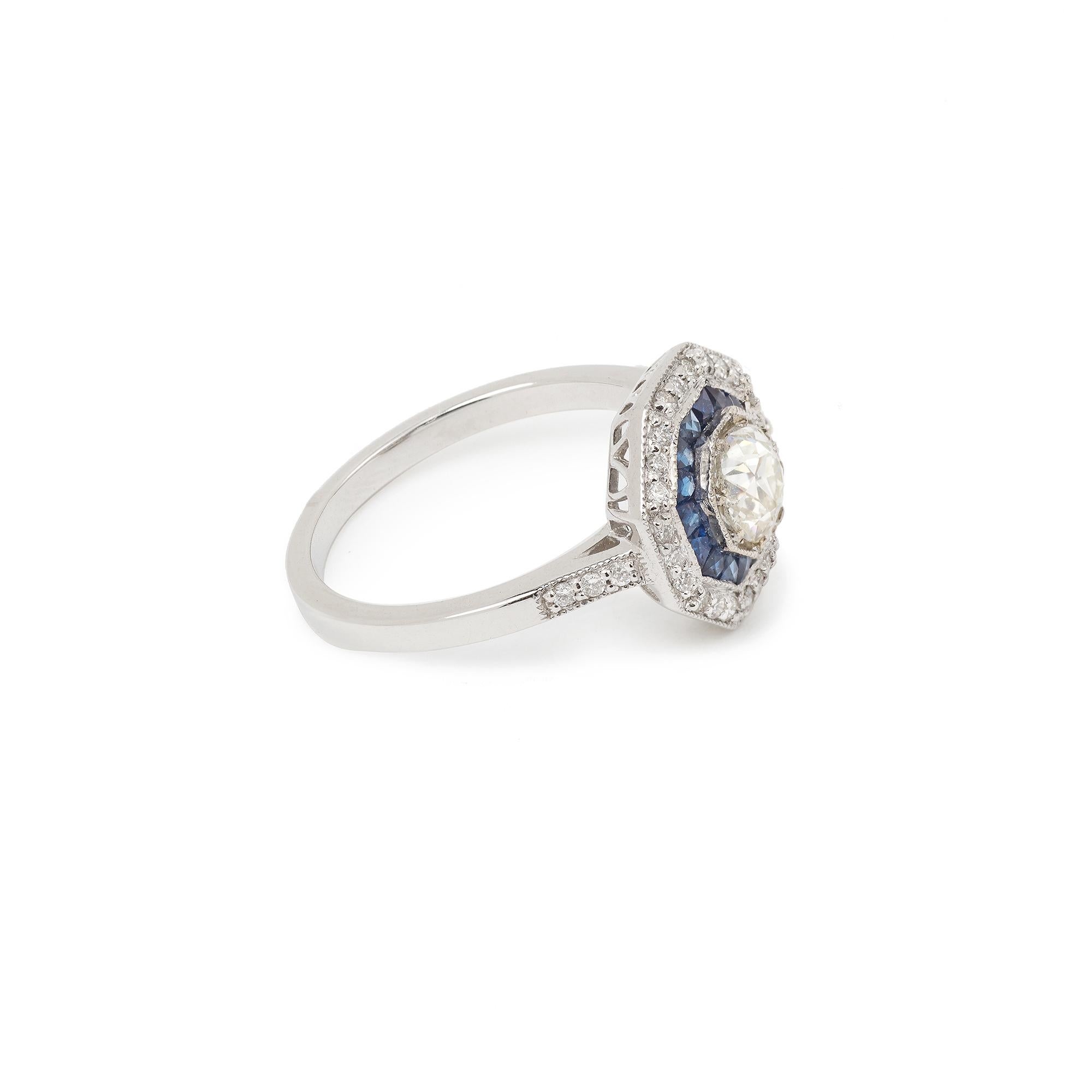 A fine Art Deco style ring in white gold set with a central old cut diamond, small diamonds and sapphires.

Ring size : 11.72 x 16.59 x 5.17 mm, (0.461 x 0.653 x 0.145 inch)

Ring weight : 3.4 g

Central diamond size : 5.47 x 3.75 mm, (0.215 x 0.145