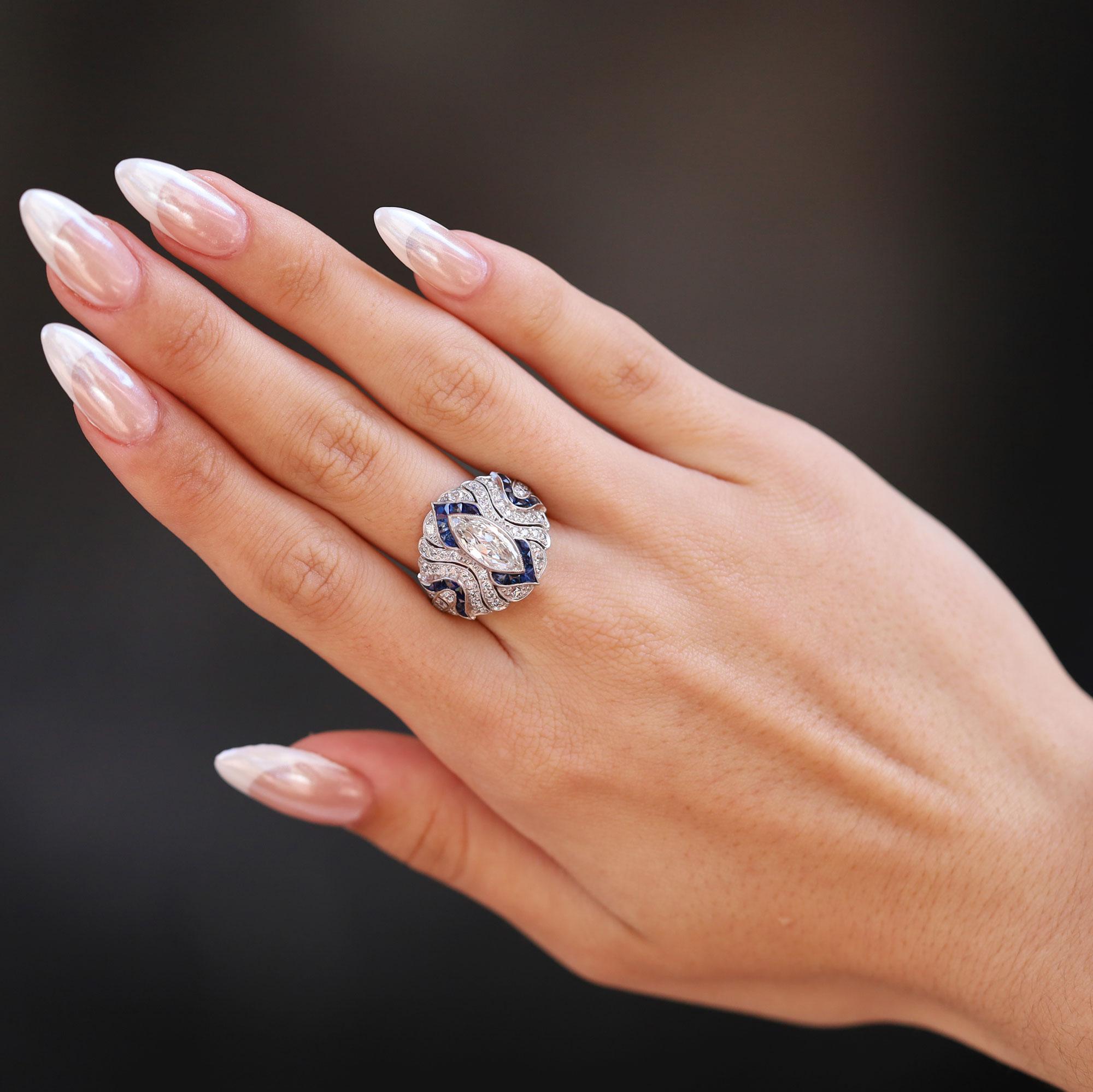 The spirit of Art Deco shines through with a 1.10 carat marquise cut diamond of a sizzling brilliance. Increasingly harder to acquire due to the size of the rough diamond required to facet its elongated shape. The curved details of this shield