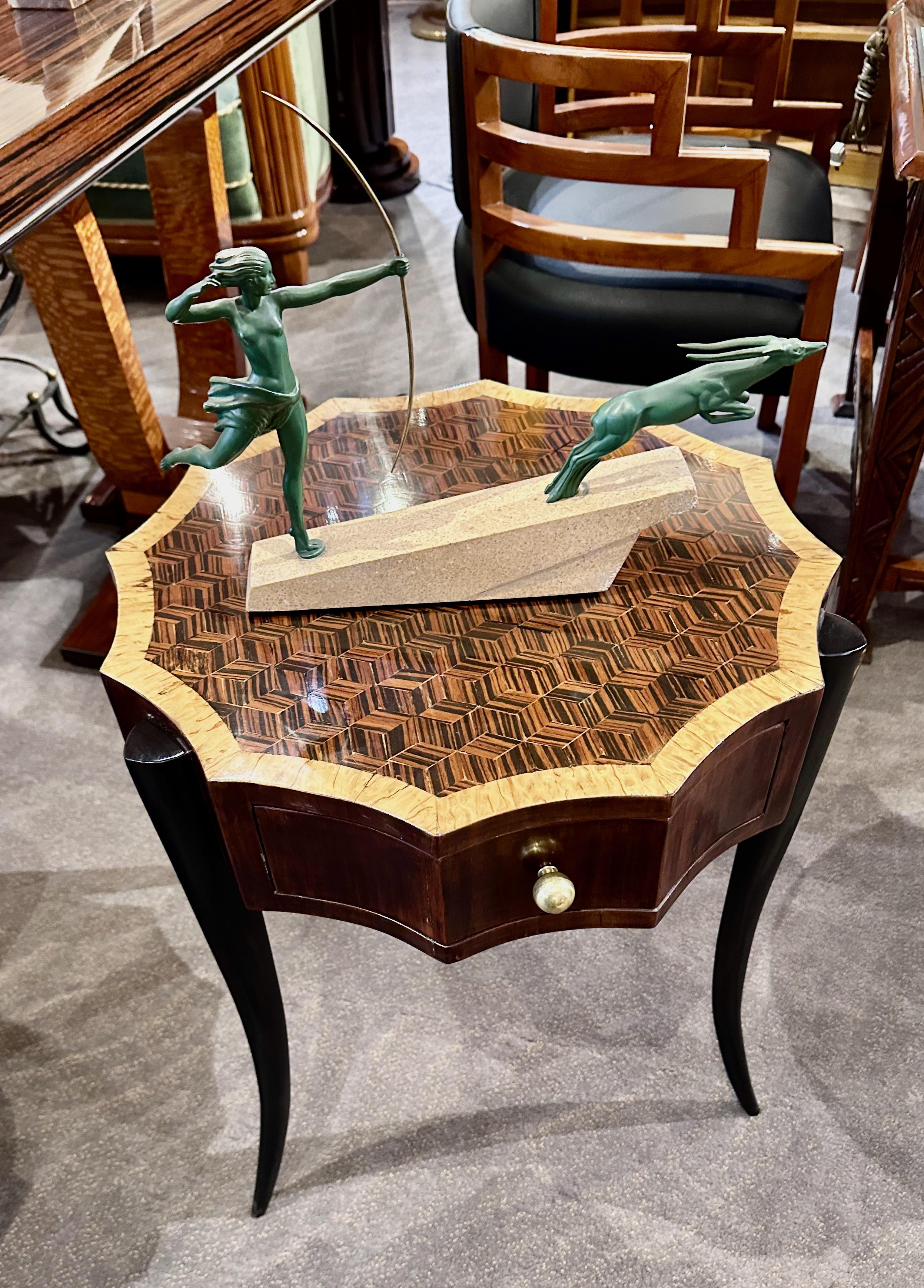 An Art Deco era exquisite 12-sided Faceted Side Table. This unique piece seamlessly blends intricate marquetry craftsmanship with geometric design elements, creating a stunning focal point for any room. We have a matching pair of these tables, but