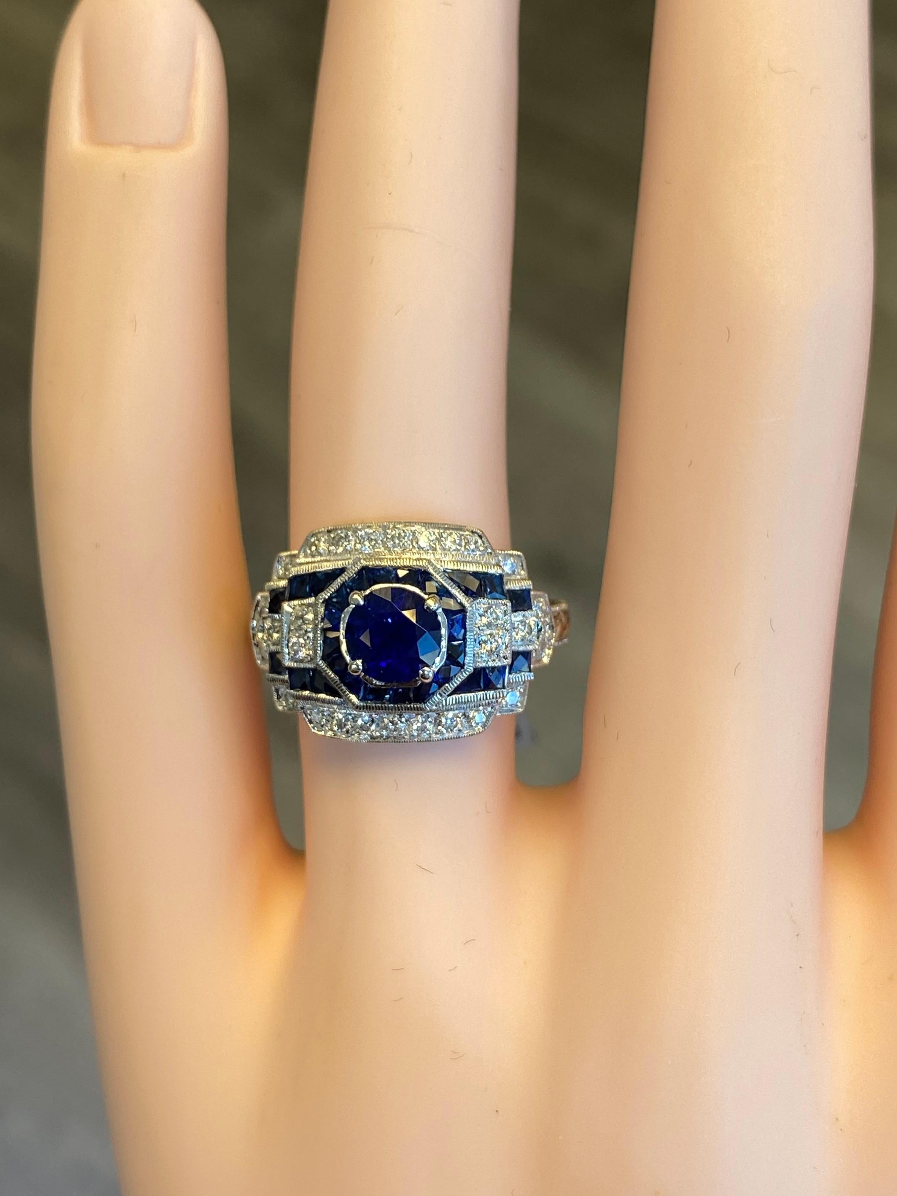 Art Deco style ring with round and french cut sapphires.
Center 1.20ct round sapphire, surrounded by 1.20ct of french cut sapphires and 0.26ct of round cut diamonds. 18k white gold with milgrain and filigree work.
2.66ct total gemstone