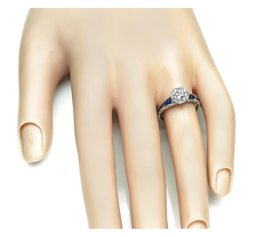 This is a stunning platinum engagement ring inspired from the Art Deco era. The ring is centered with sparkling old mine cut diamond that weighs approximately 1.34ct. The color of the diamond is F-G and the clarity is VS1. The diamond is accentuated