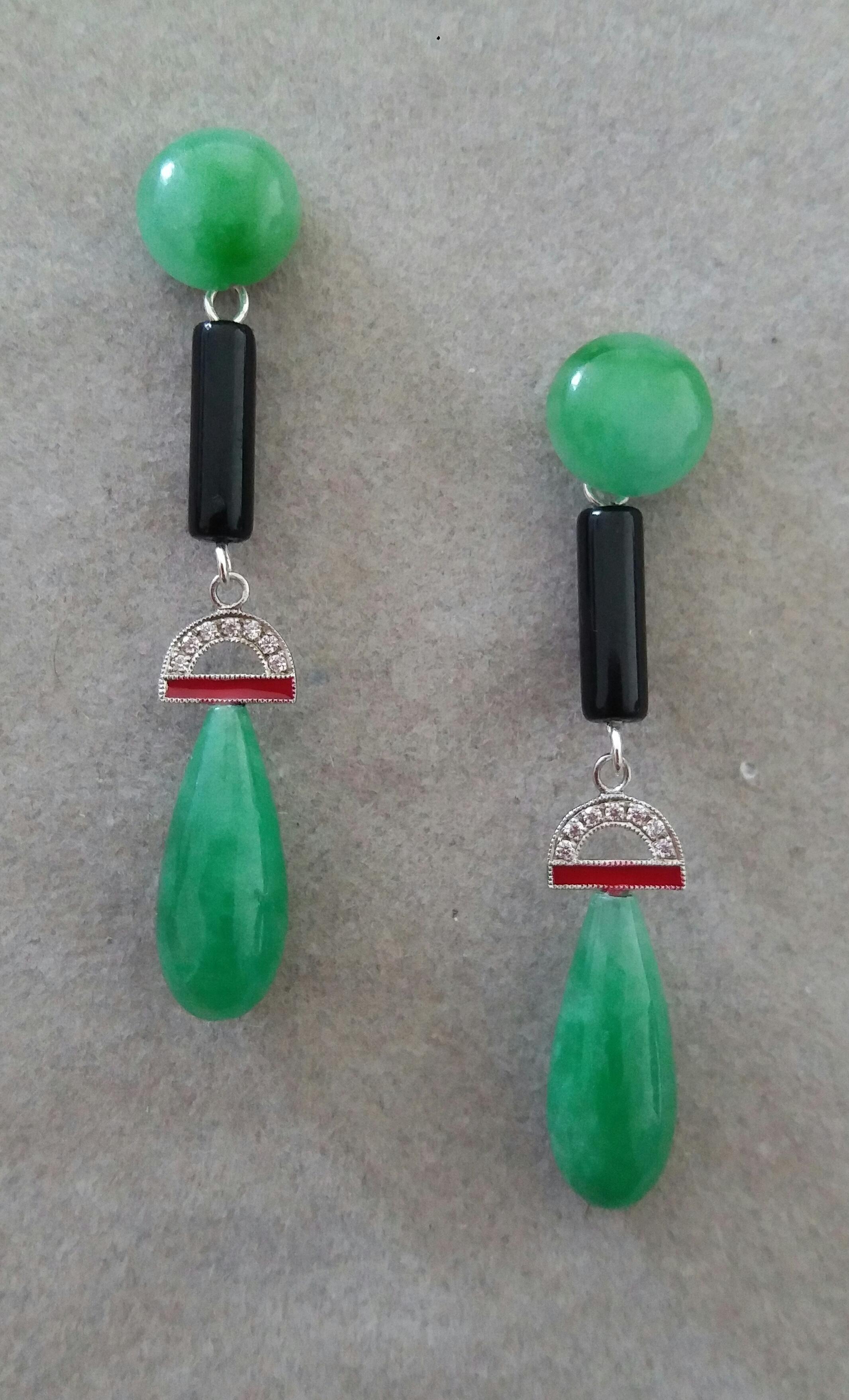 In these light weight ( 7 grams) classic Art Deco Earrings we have 2 round jade buttons of 10 mm in diameter on top , the central part is in gold , 14 full cut round diamonds, red enamel and 2 small black onyx cylinders , the bottom part is composed